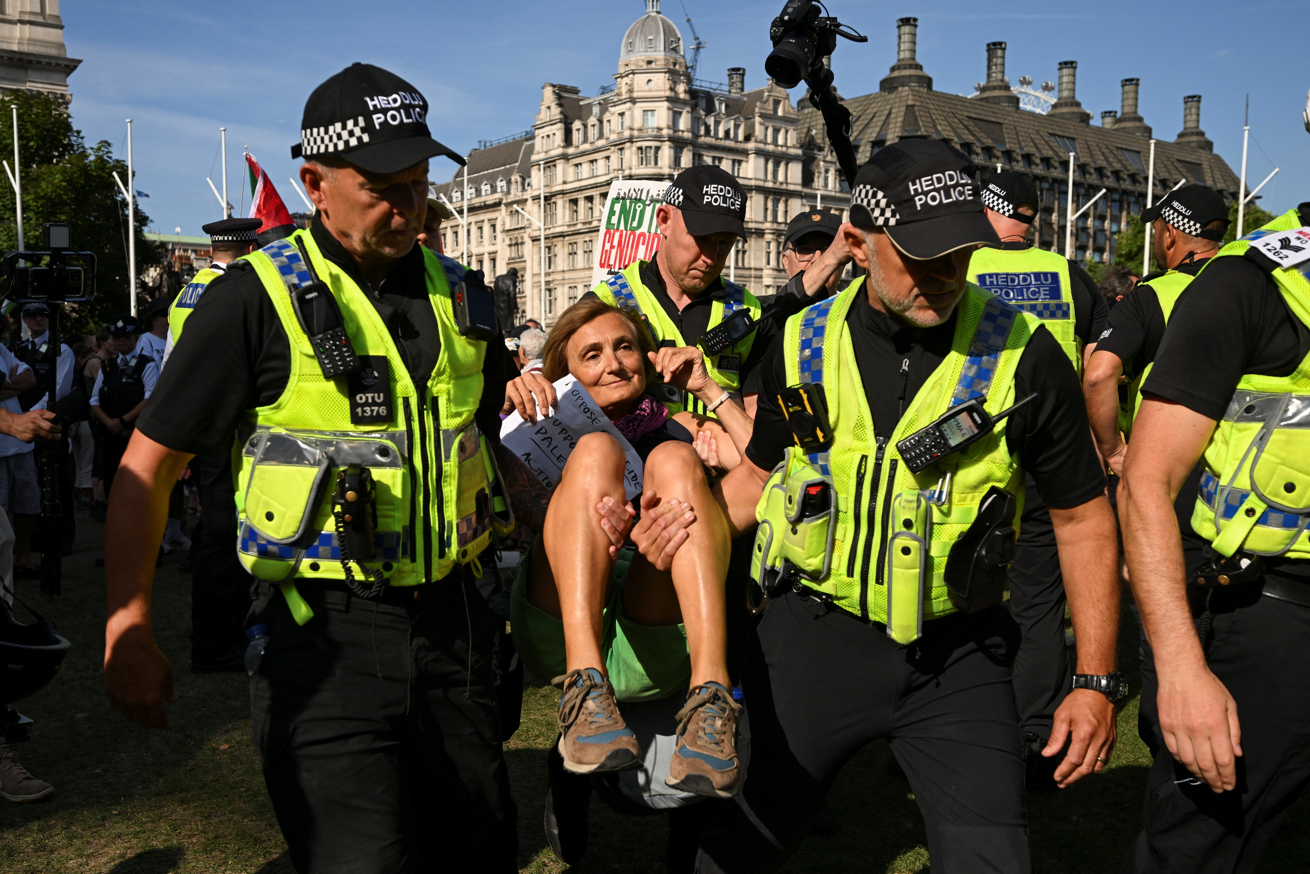 Police detain a protester in London