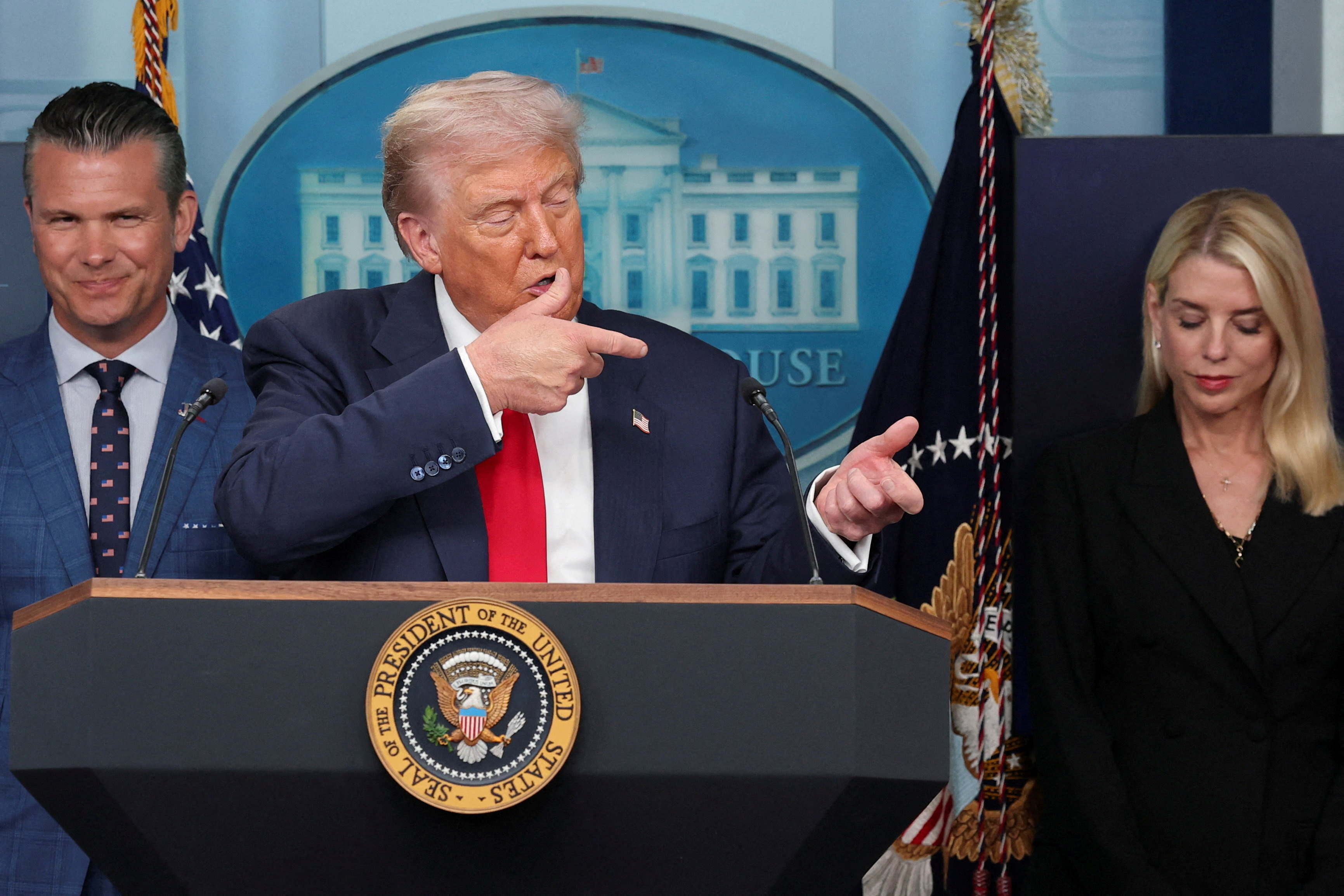 U.S. President Donald Trump gestures as he speaks about Javelin anti-tank missiles next to U.S. Defense Secretary Pete Hegseth and U.S. Attorney General Pam Bondi during a press conference about deploying federal law enforcement agents in Washington to bolster the local police presence, in the Press Briefing Room at the White House, in Washington D.C., U.S., August 11, 2025. REUTERS/Jonathan Ernst TPX IMAGES OF THE DAY