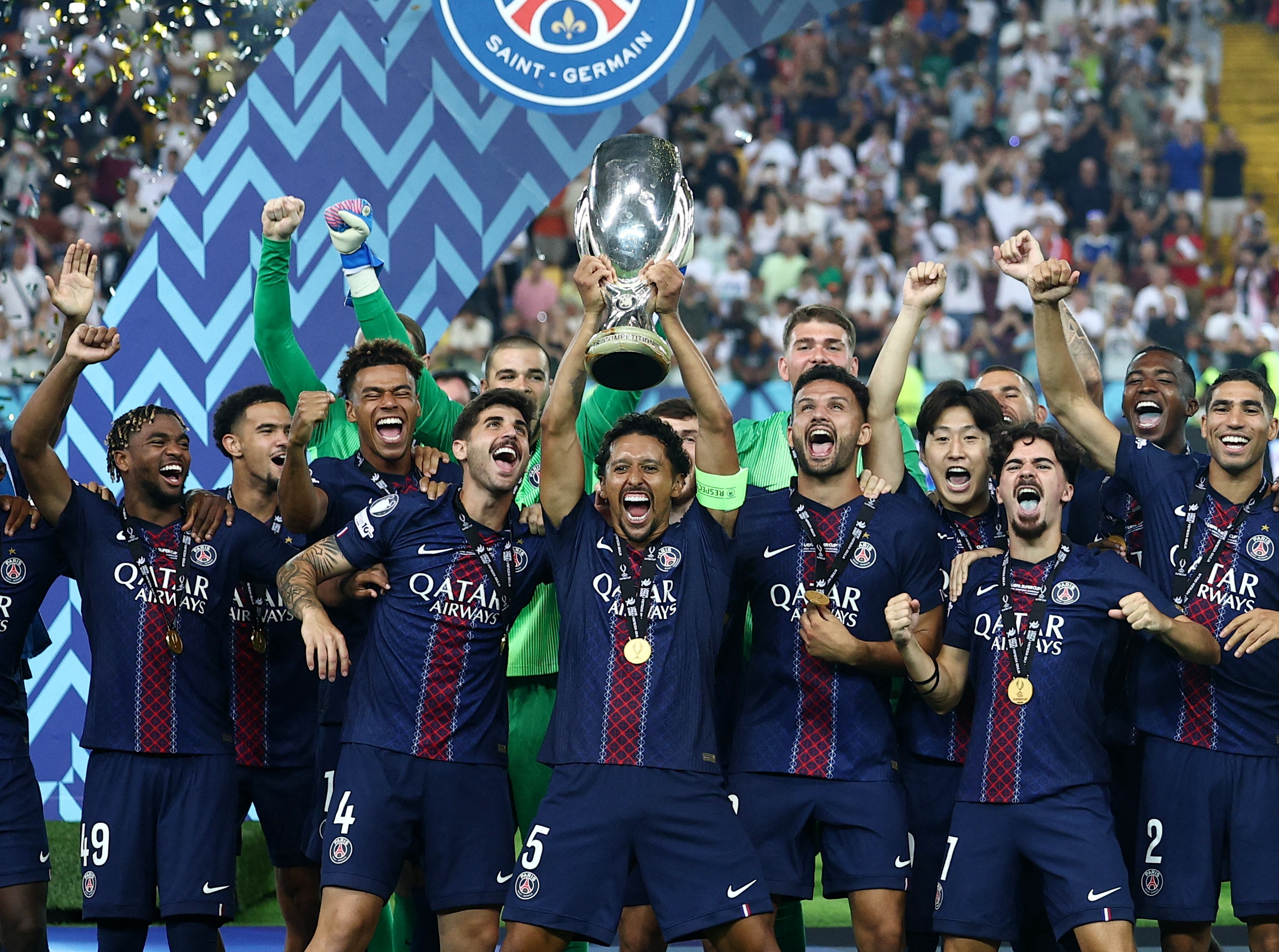 PSG's Marquinhos lifts the trophy as he celebrates with teammates after winning the UEFA Super Cup