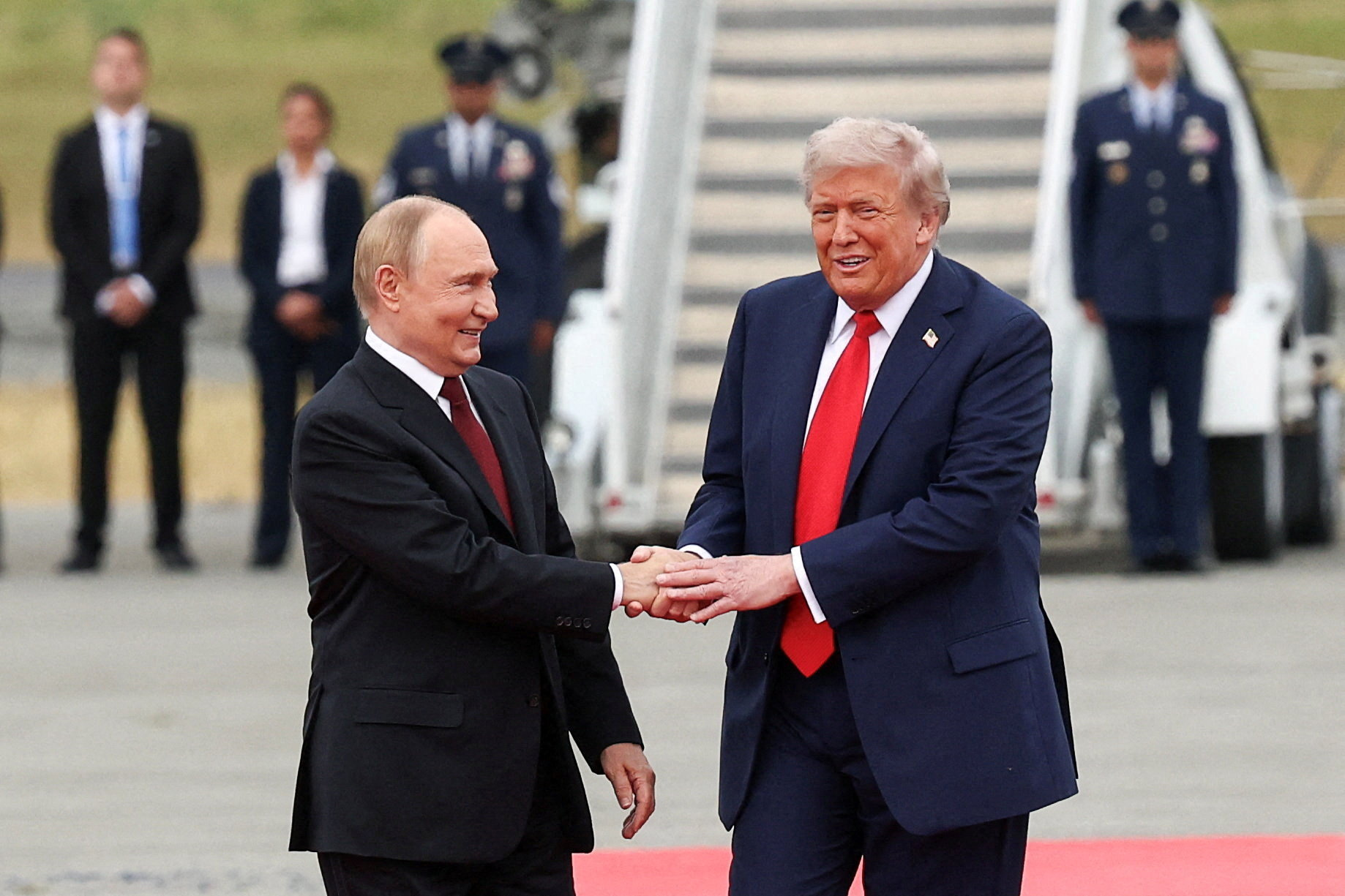 Trump shakes hands with Putin