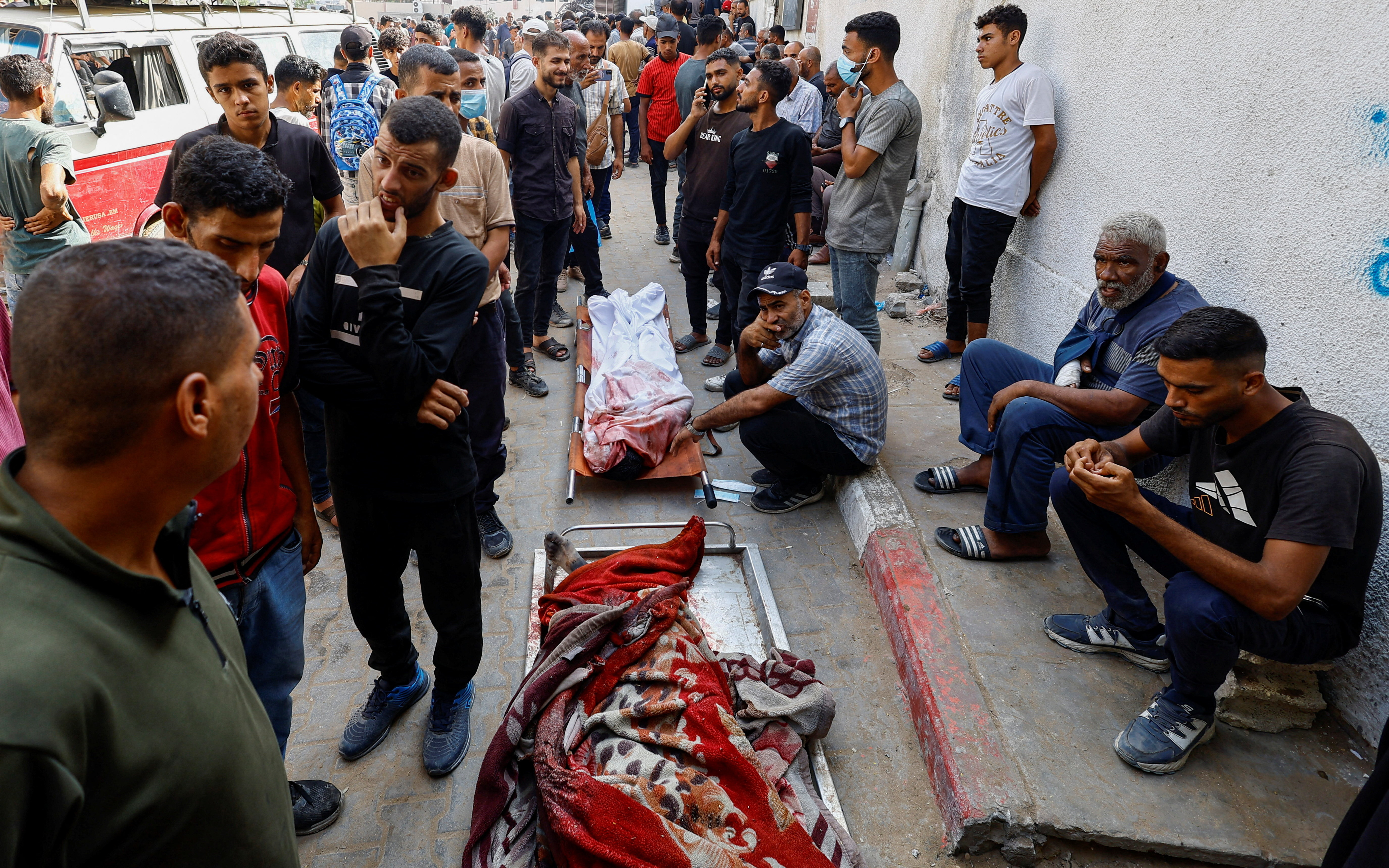 Mourners gather next to bodies, at the funeral of Palestinians killed in Israeli fire while seeking aid on Friday, at Al-Shifa Hospital, in Gaza City, August 16, 2025. [Mahmoud Issa/Reuters]