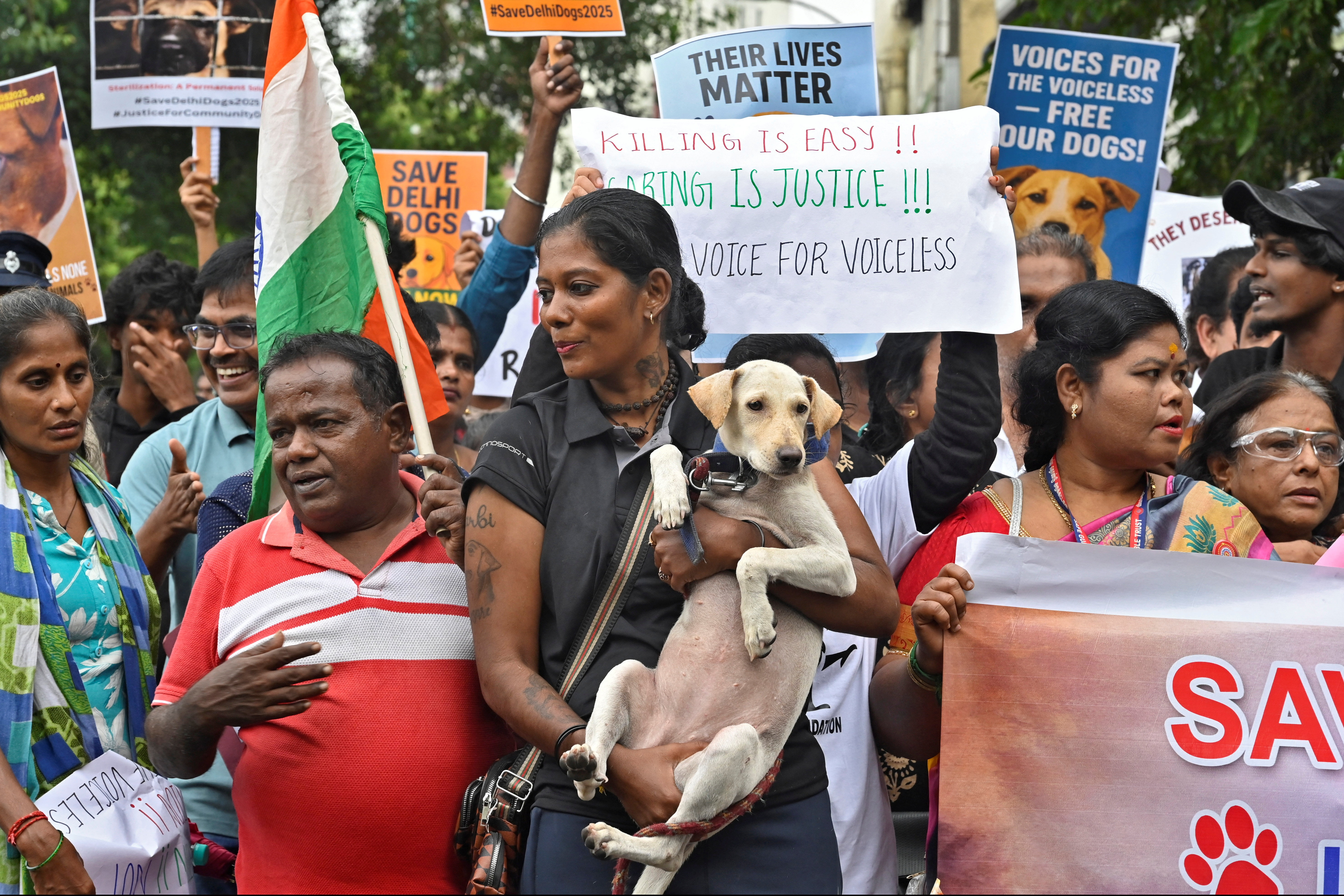 A woman holds a dog as she and other animal lovers attend a protest rally, after India's top court last week ordered authorities in the capital Delhi and its suburbs to relocate all stray dogs to shelters within eight weeks, in Chennai, India, August 17, 2025. REUTERS/Riya Mariyam R