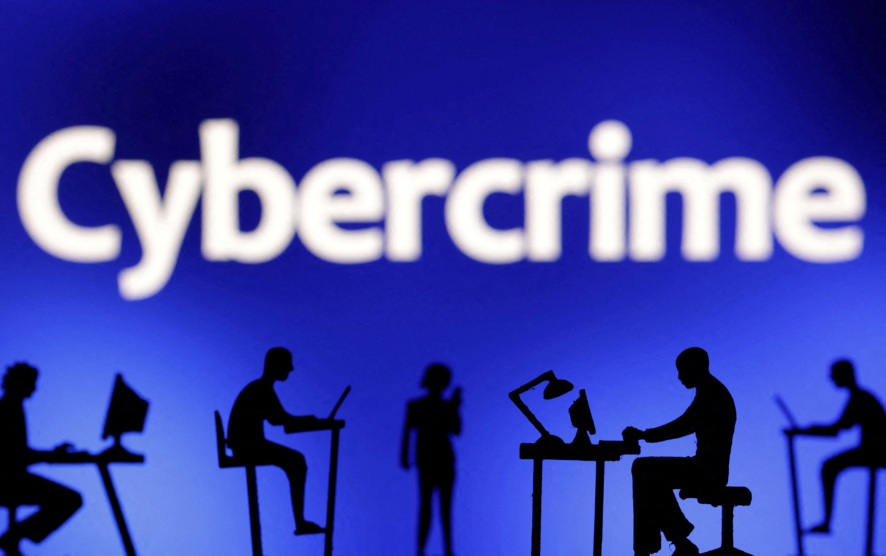 FILE PHOTO: Figurines with computers and smartphones are seen in front the word "Cybercrime" in this illustration taken, February 19, 2024. REUTERS/Dado Ruvic/File Photo