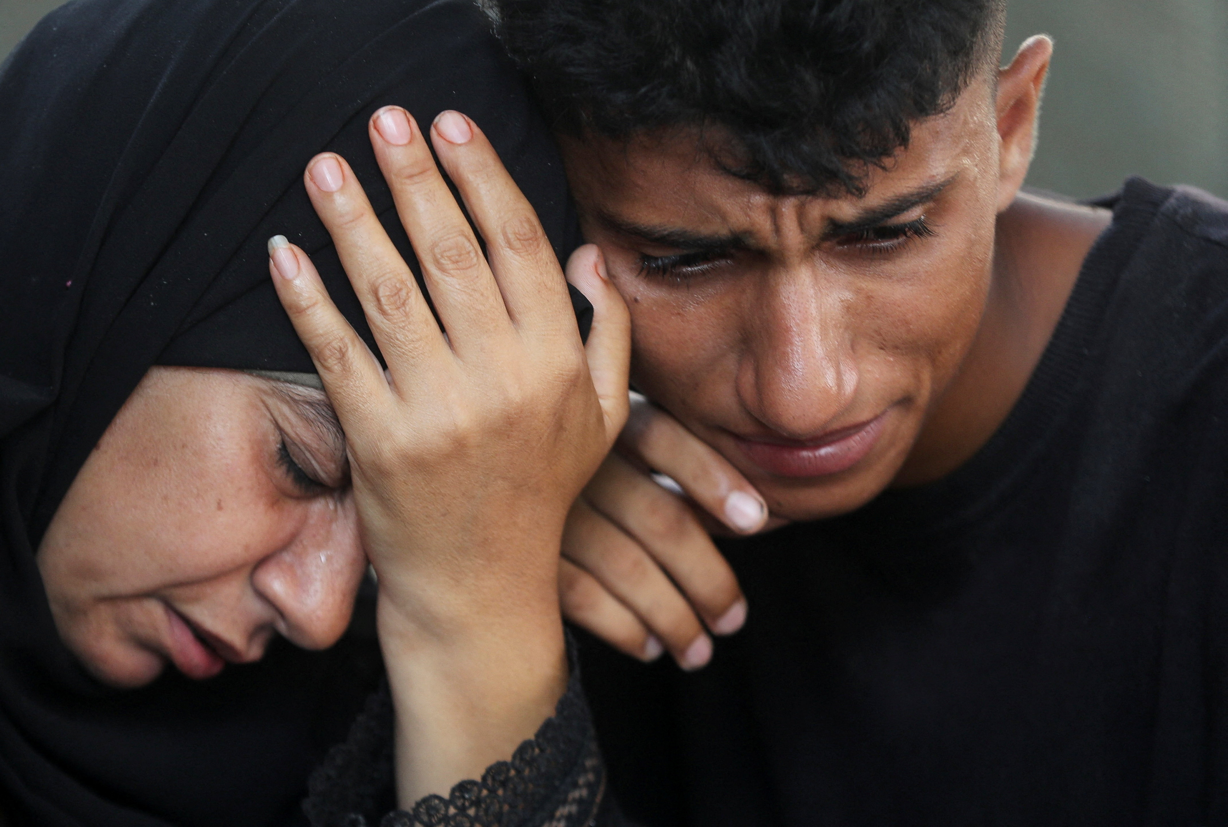 Mourners react during the funeral of Palestinians