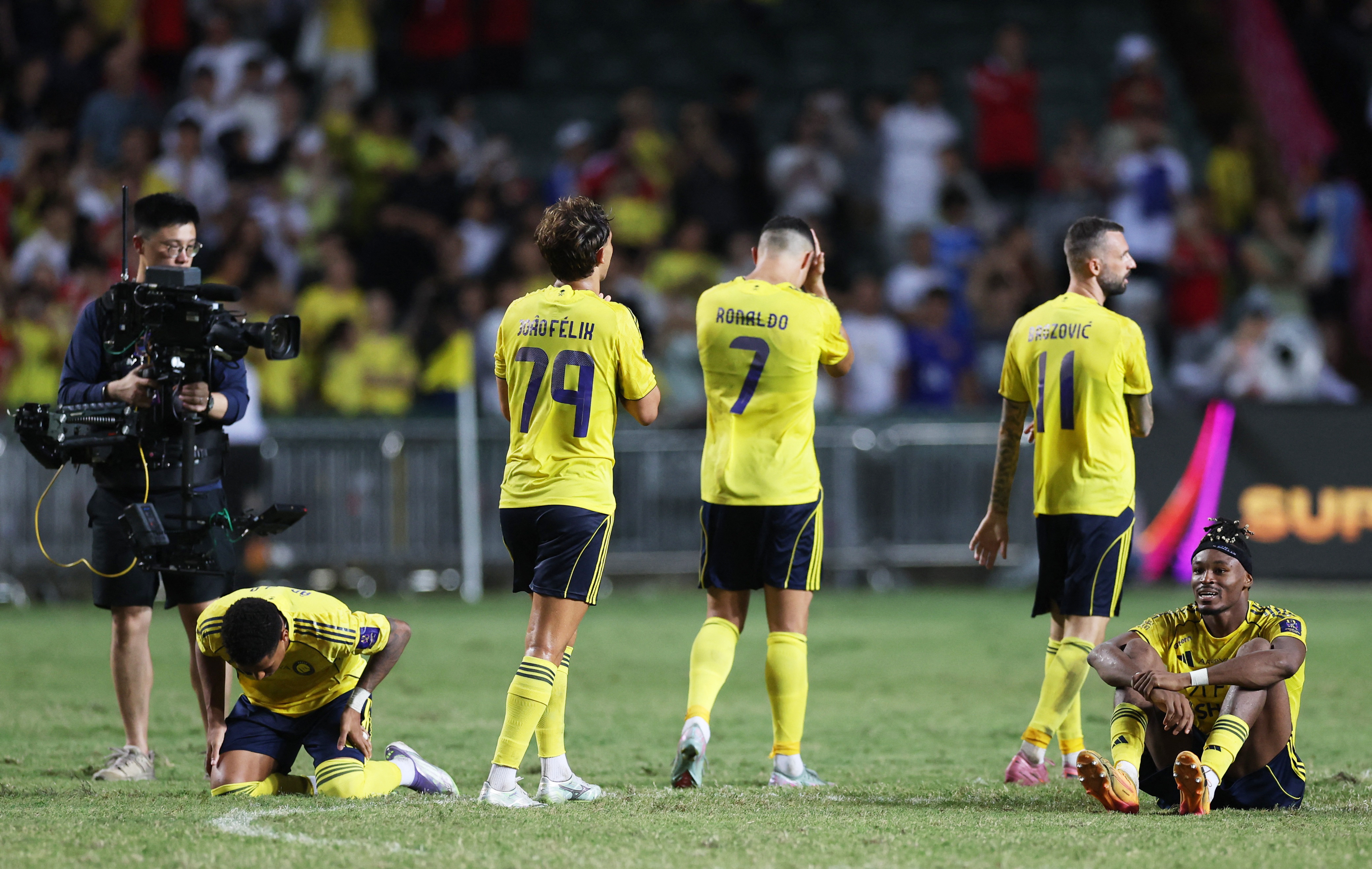 Al Nassr's Cristiano Ronaldo with Joao Felix and teammates as he looks dejected after the match 