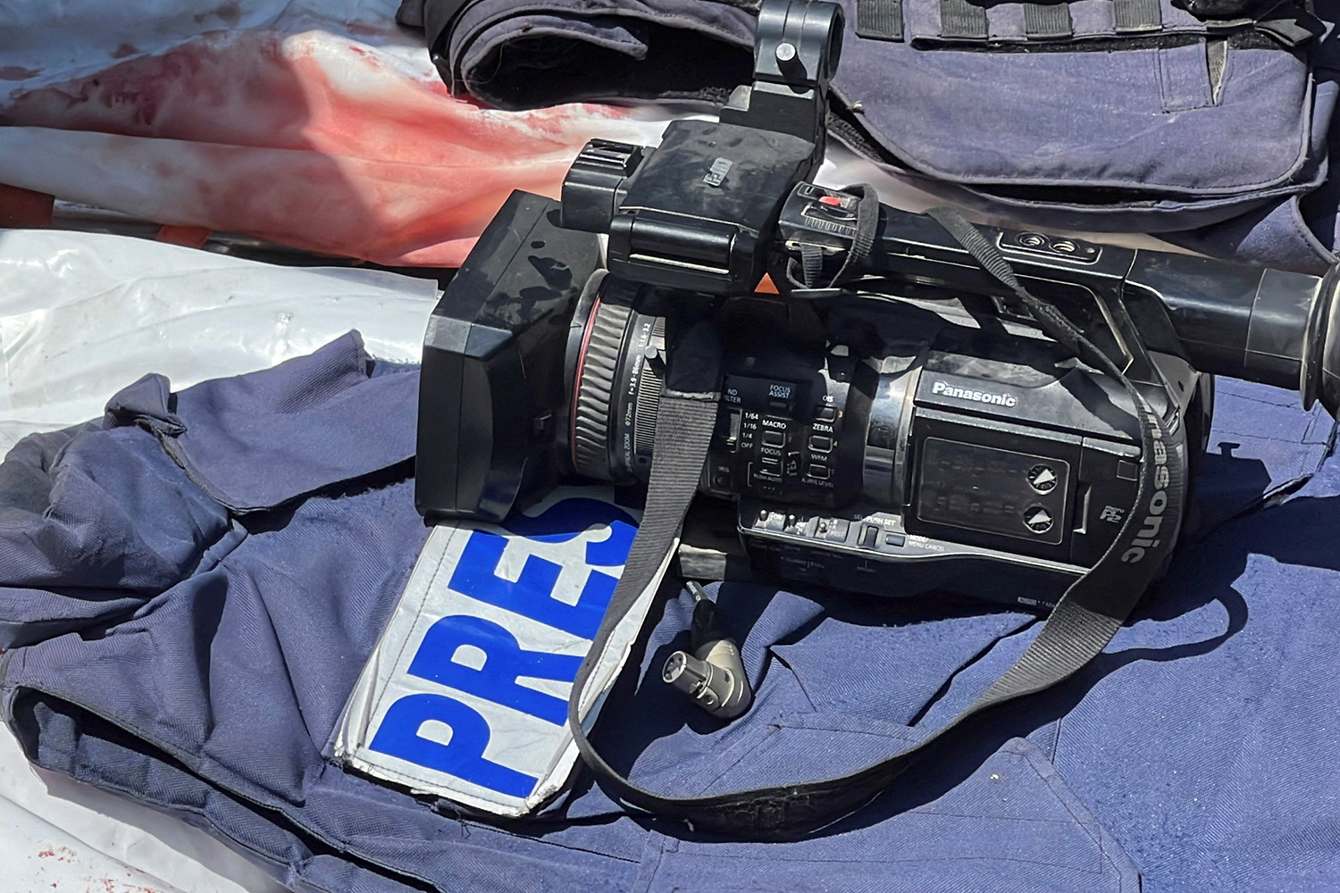 SENSITIVE MATERIAL. THIS IMAGE MAY OFFEND OR DISTURB Flak jackets and cameras are placed on the bodies of journalists Mohammed Salama, who Qatar-based Al Jazeera said worked for the broadcaster, and Hussam al-Masri, who was a contractor for Reuters, after they were killed in Israeli strikes on Nasser hospital, in Khan Younis in the southern Gaza Strip, August 25, 2025. REUTERS/Stringer TPX IMAGES OF THE DAY