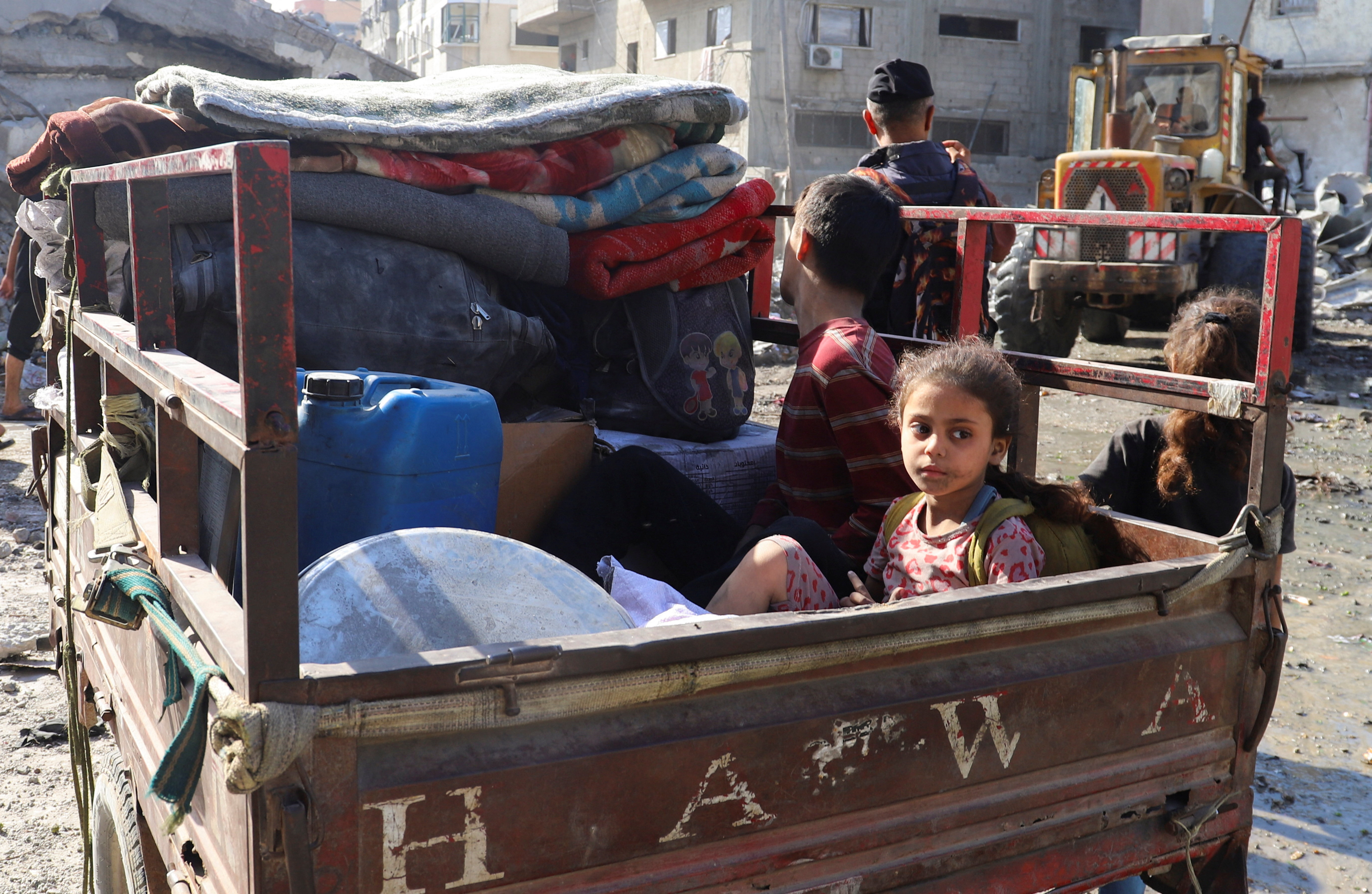 A Palestinian child looks on as she sits in a vehicle