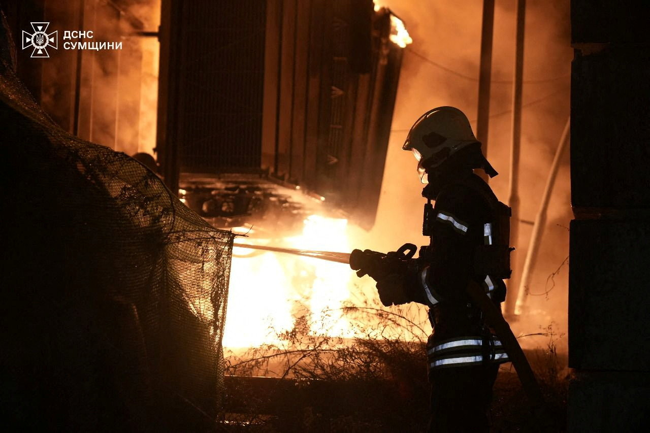 A firefighter works at the site of a Russian drone attack in Ukraine's Sumy region
