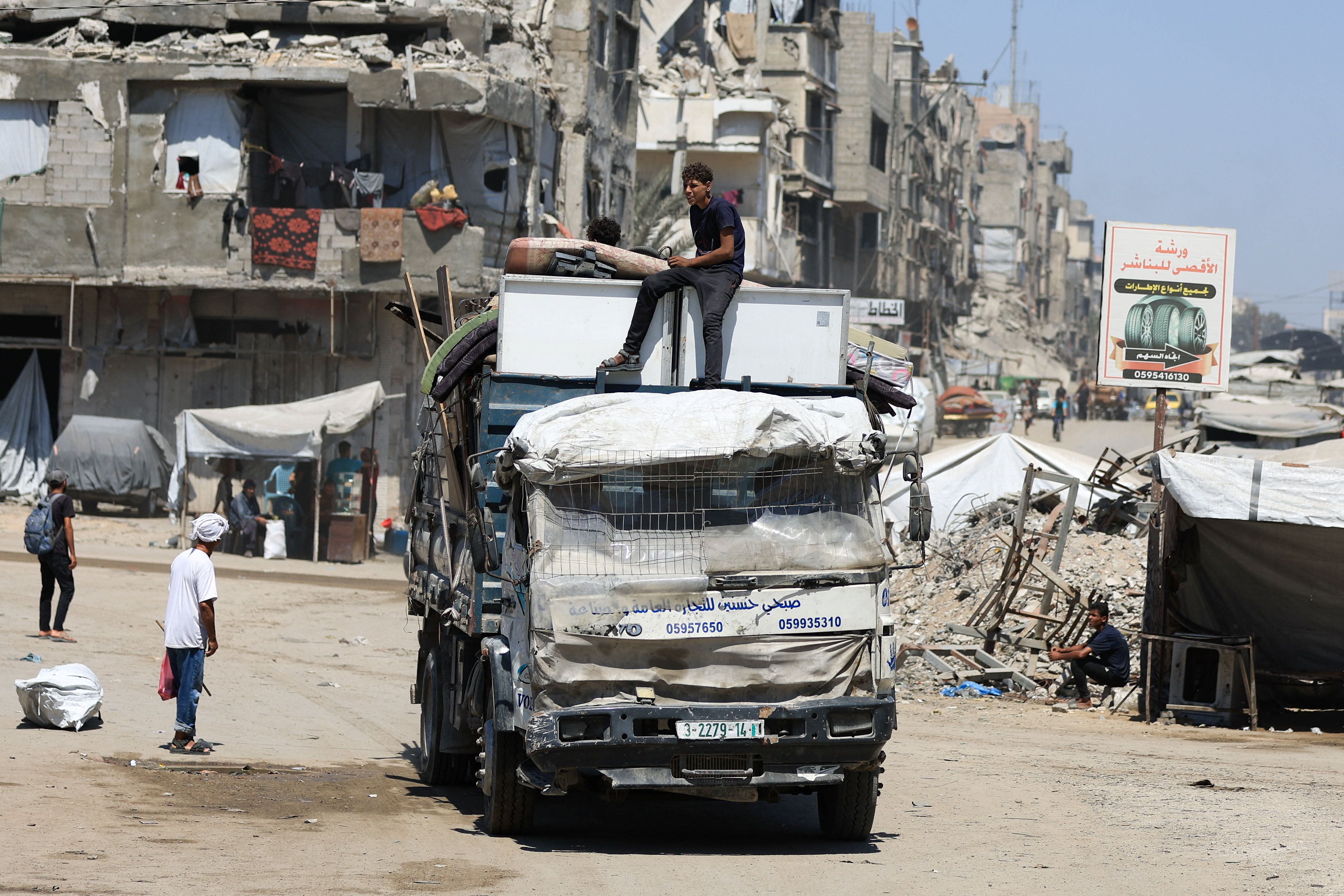 Displaced Palestinians ride on a vehicle loaded with belongings as they flee from one area to another within Gaza City, amid an Israeli military operation, in Gaza City, August 29, 2025. [Dawoud Abu Alkas/Reuters]