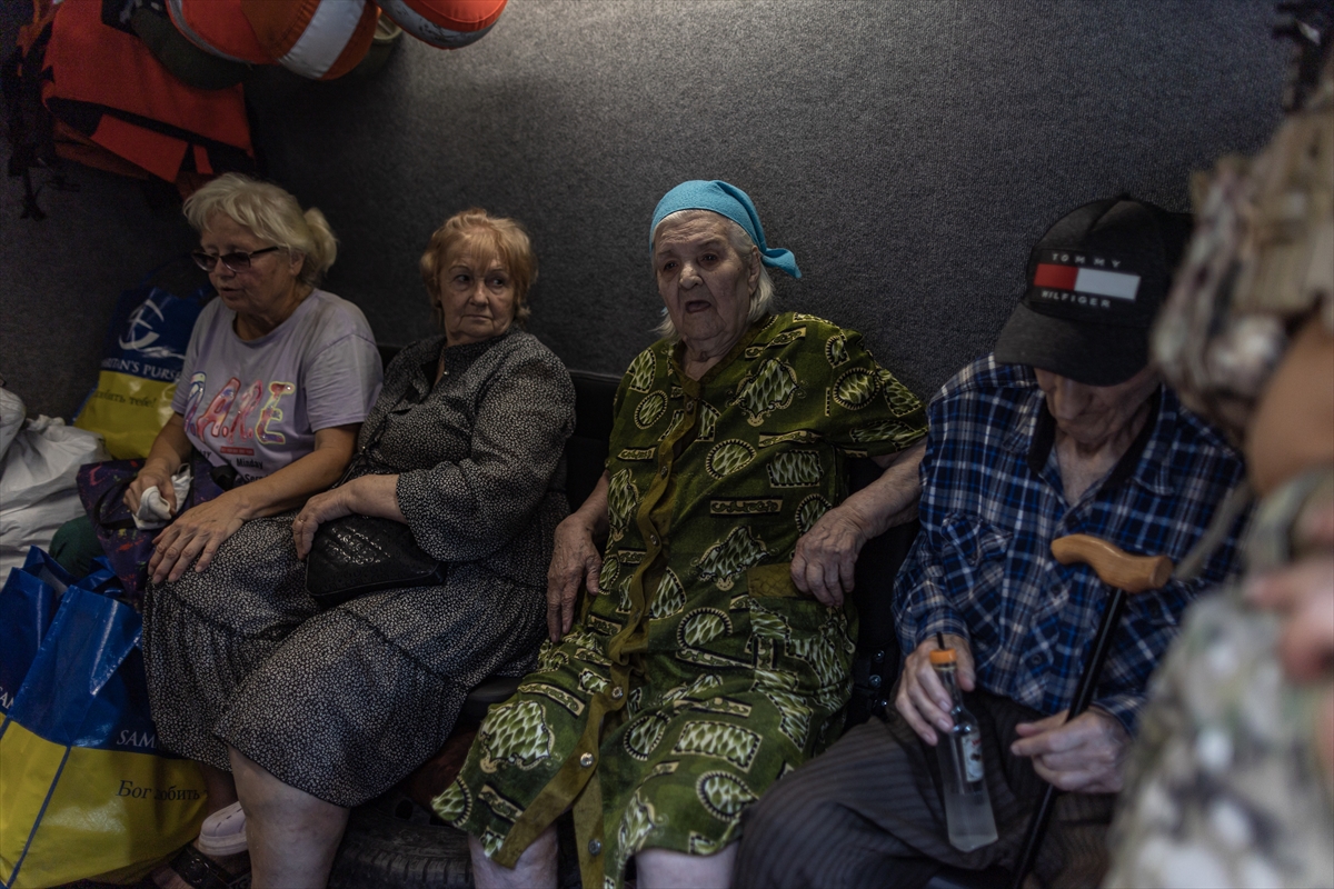 4 elderly people sit in the back of a van