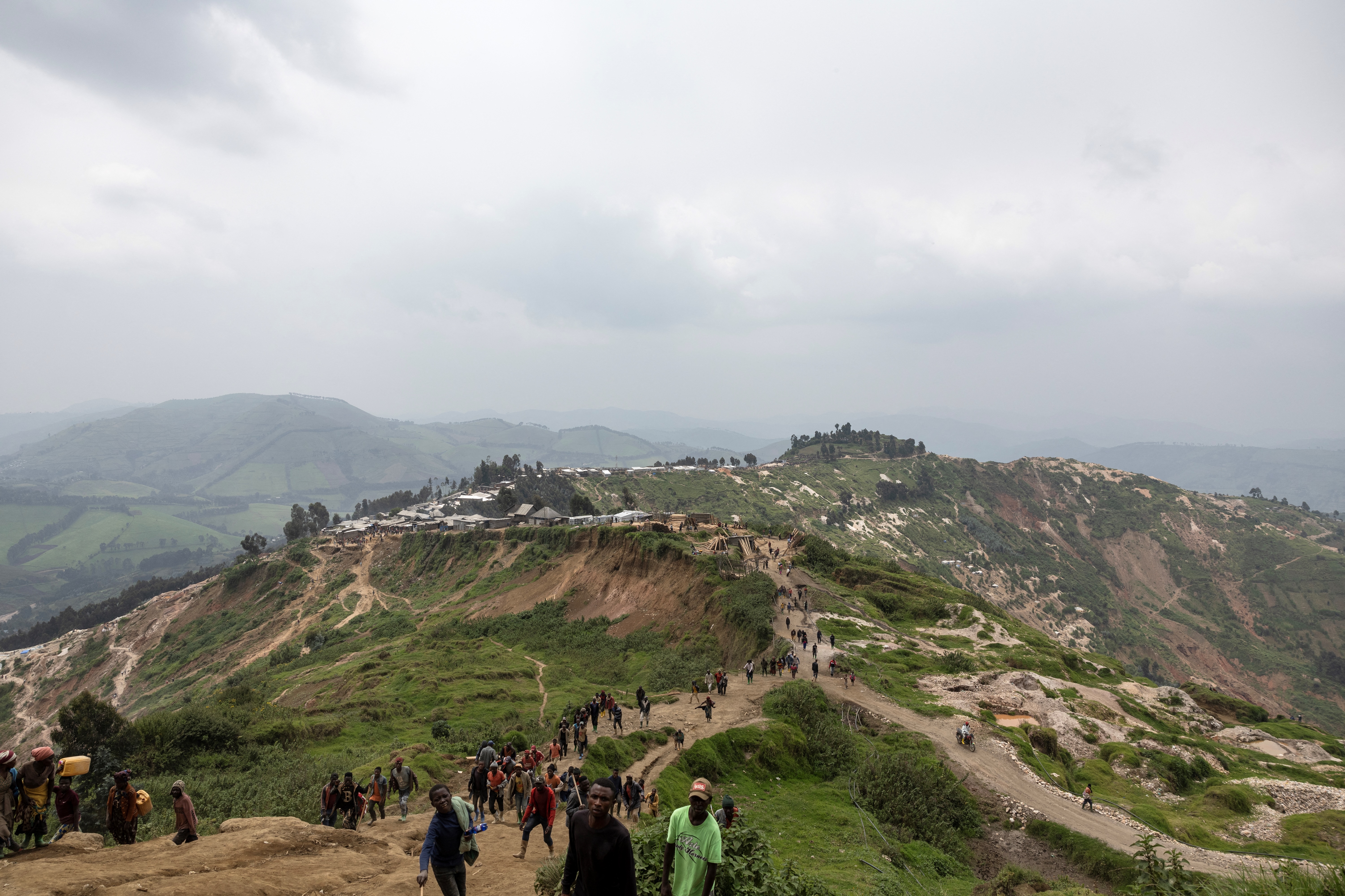 Miners walk towards the mining pits in Rubaya, DR Congo on March 5, 2025.