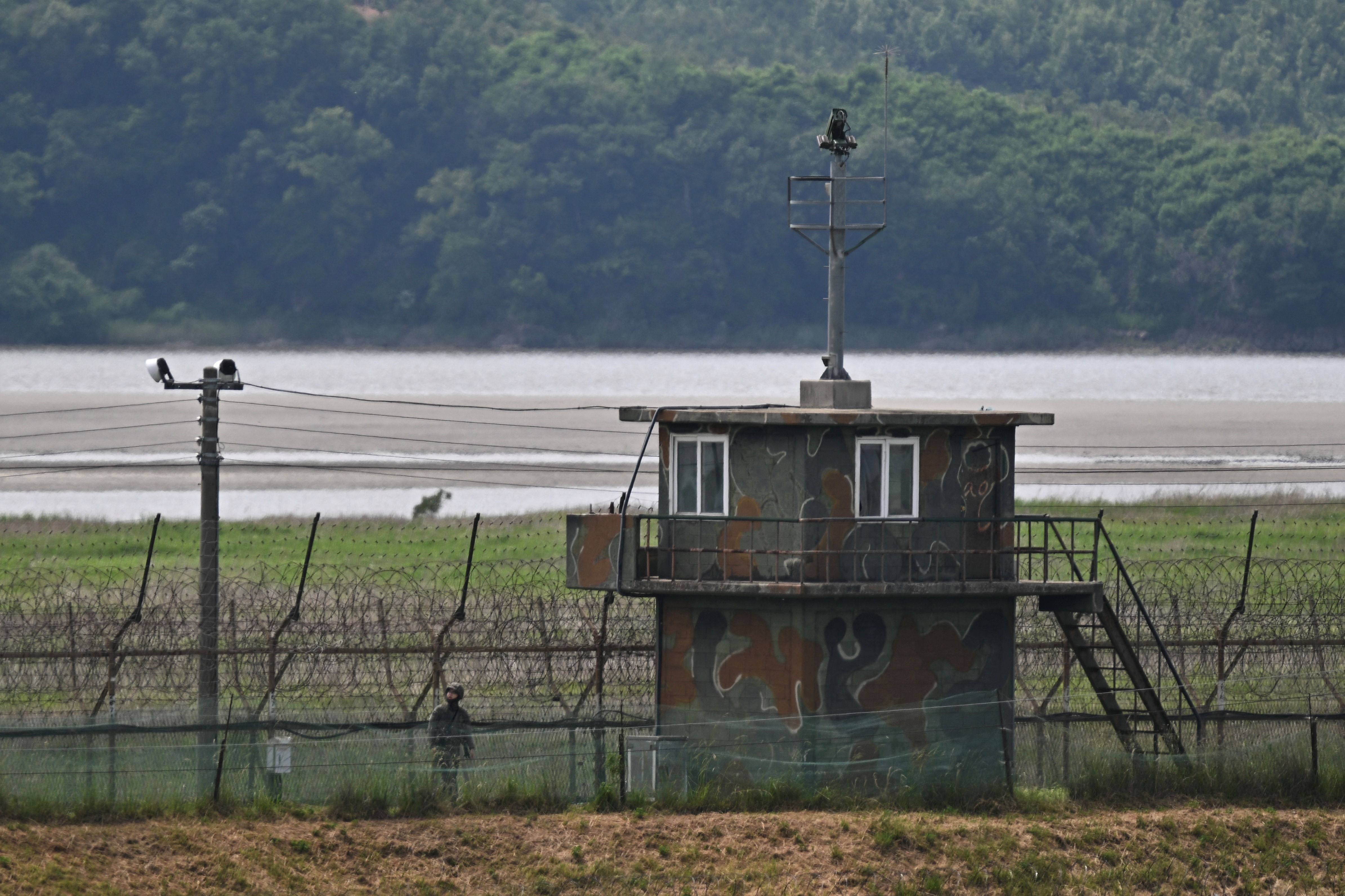 A South Korean soldier patrols the border with North Korea, divided by the Imjin River in Paju, north of Seoul, on June 5, 2025. (Photo by Pedro PARDO / AFP)