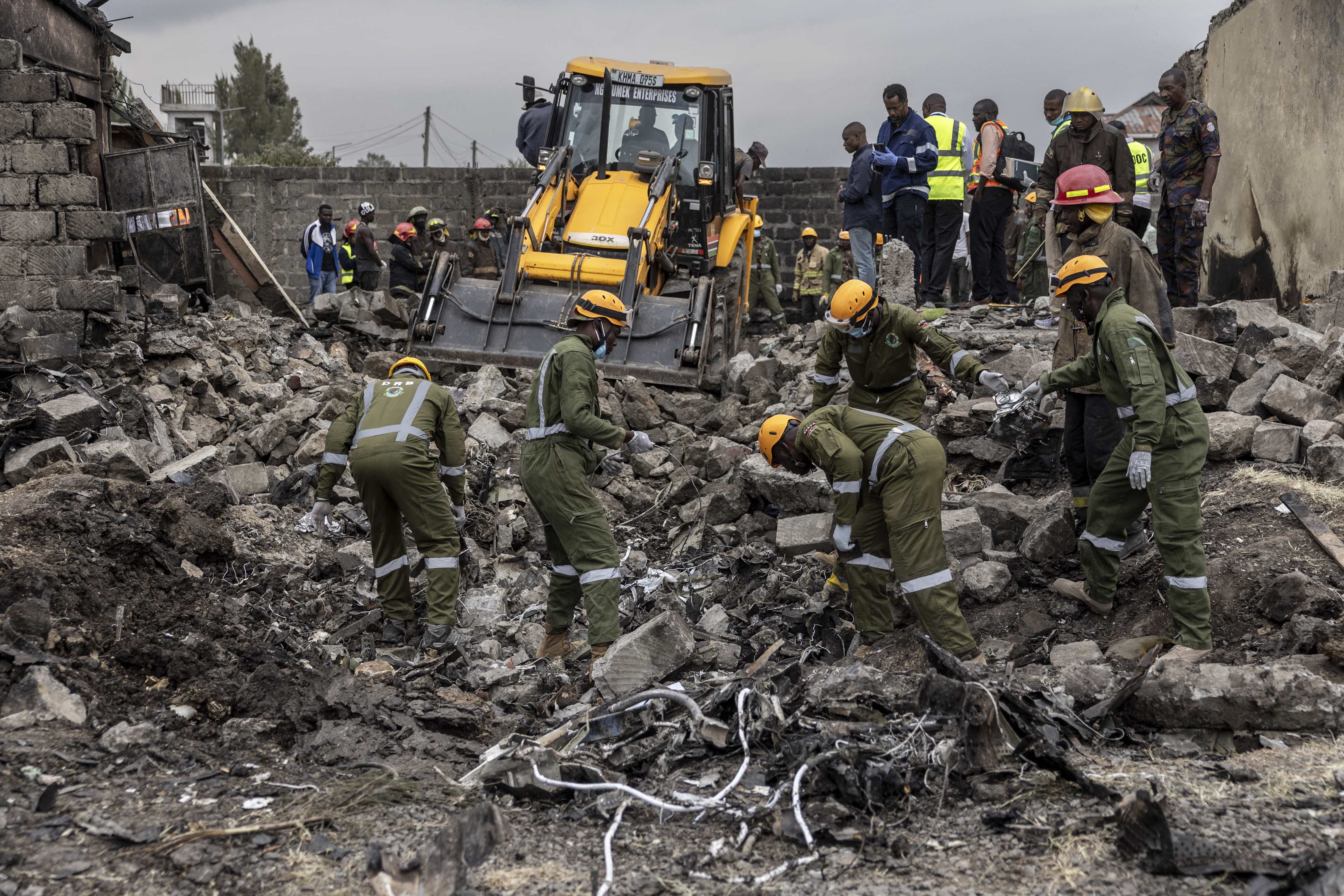 Rescuers search through the wreckage at the site where a Kenyan medical plane crashed, killing at least 6 people, on the outskirts of Nairobi on August 7, 2025.