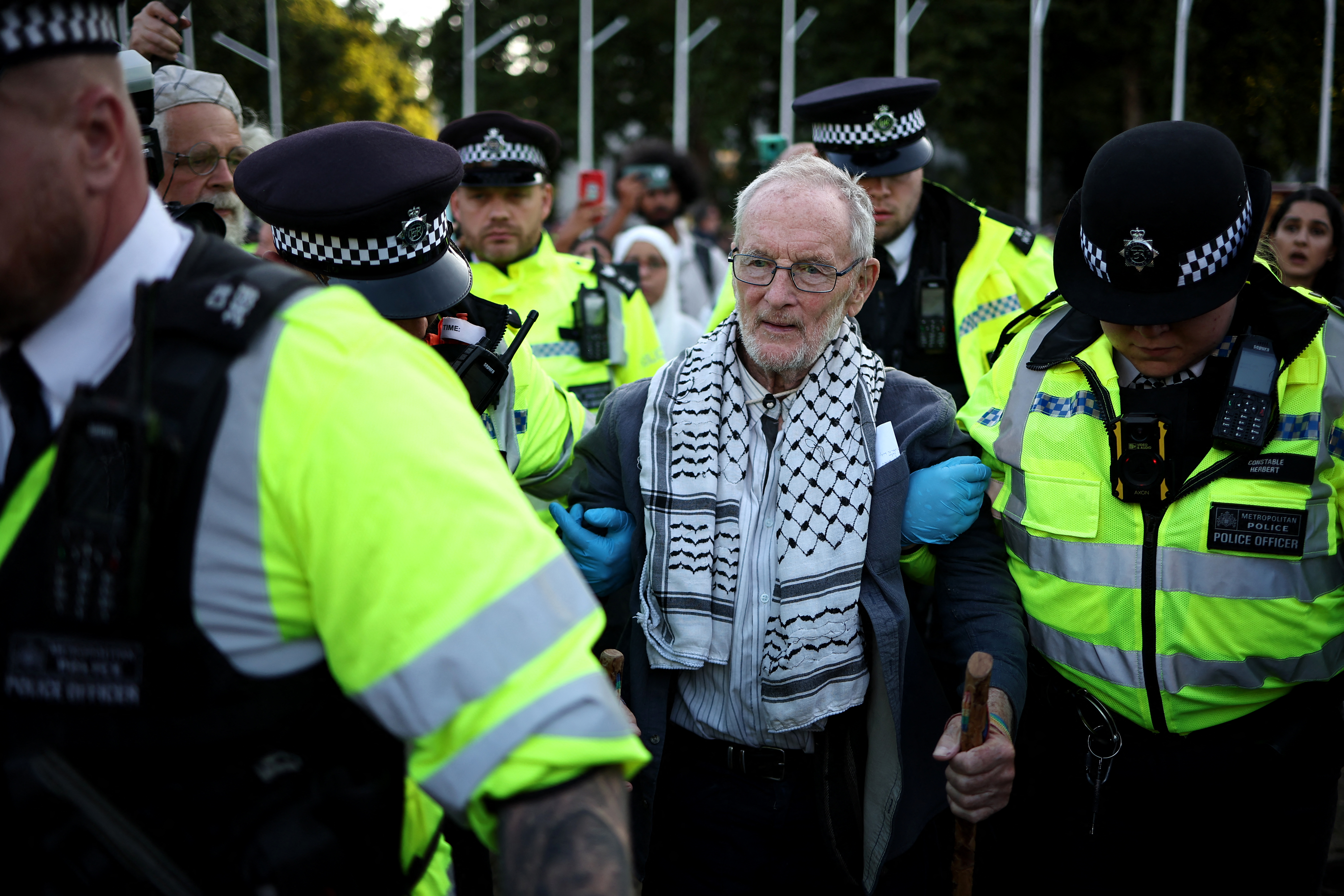 A protester is led away by police officers at a "Lift The Ban" demonstration in support of the proscribed group Palestine Action in Parliament Square, central London, United Kingdom on August 9, 2025.