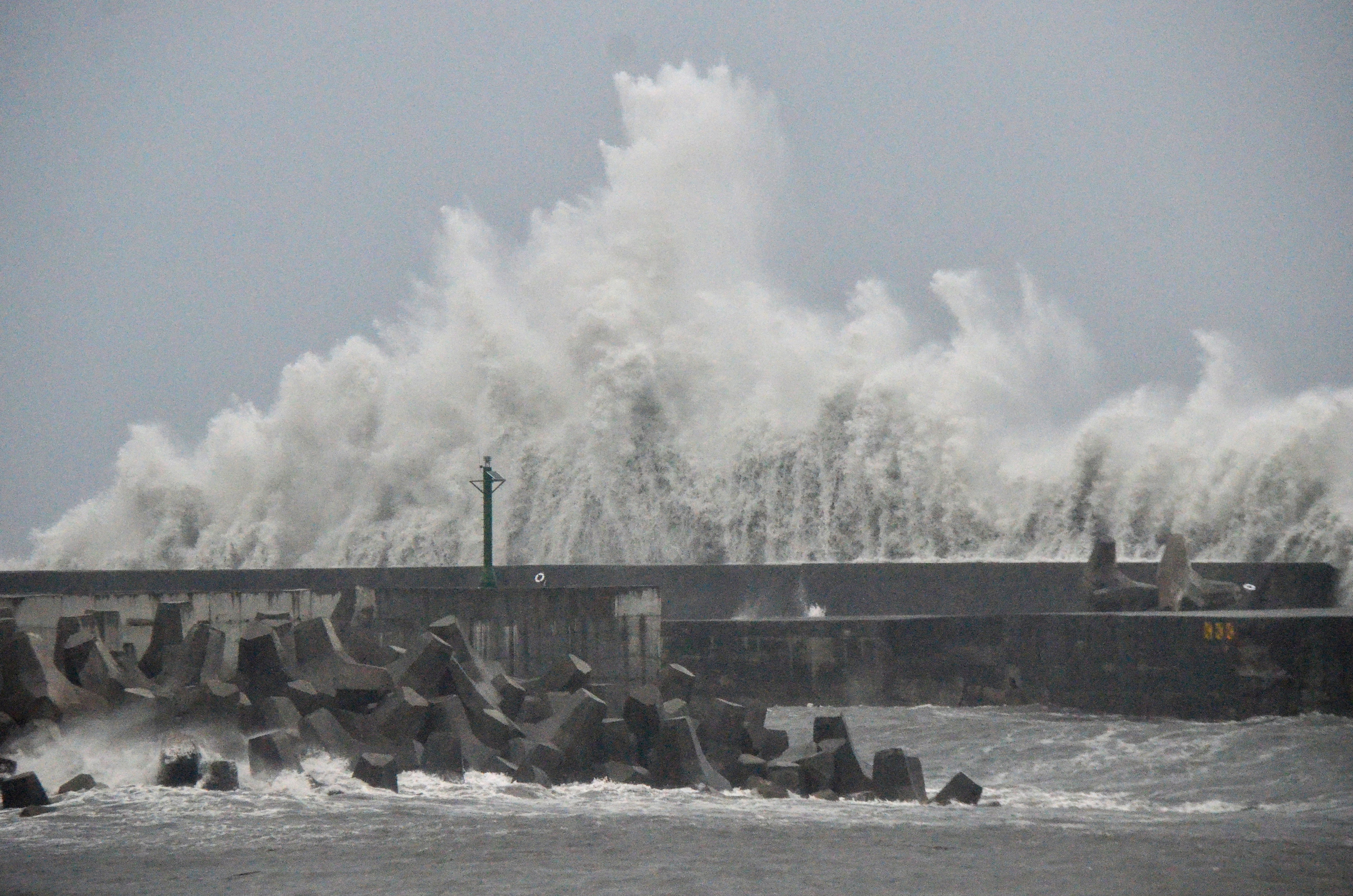 This picture taken and released by Taiwans Central News Agency (CNA) on August 13, 2025 shows waves generated by Typhoon Podul breaking along the coast in Taitung. Thousands of people sheltered and fishermen secured their boats across storm-battered southern Taiwan on August 13 as Typhoon Podul intensified on its approach to the island. (Photo by CNA / AFP)