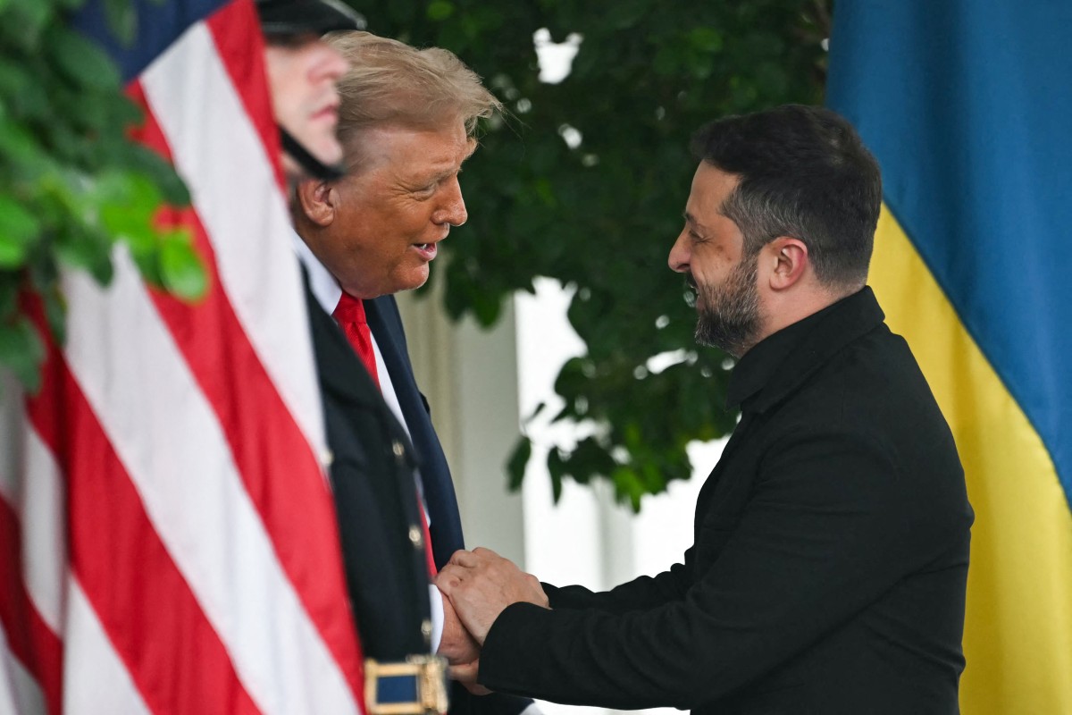 Zelenskyy is greeted by Trump upon arrival at the White House West Wing. [Andrew Caballero-Reynolds/ AFP]