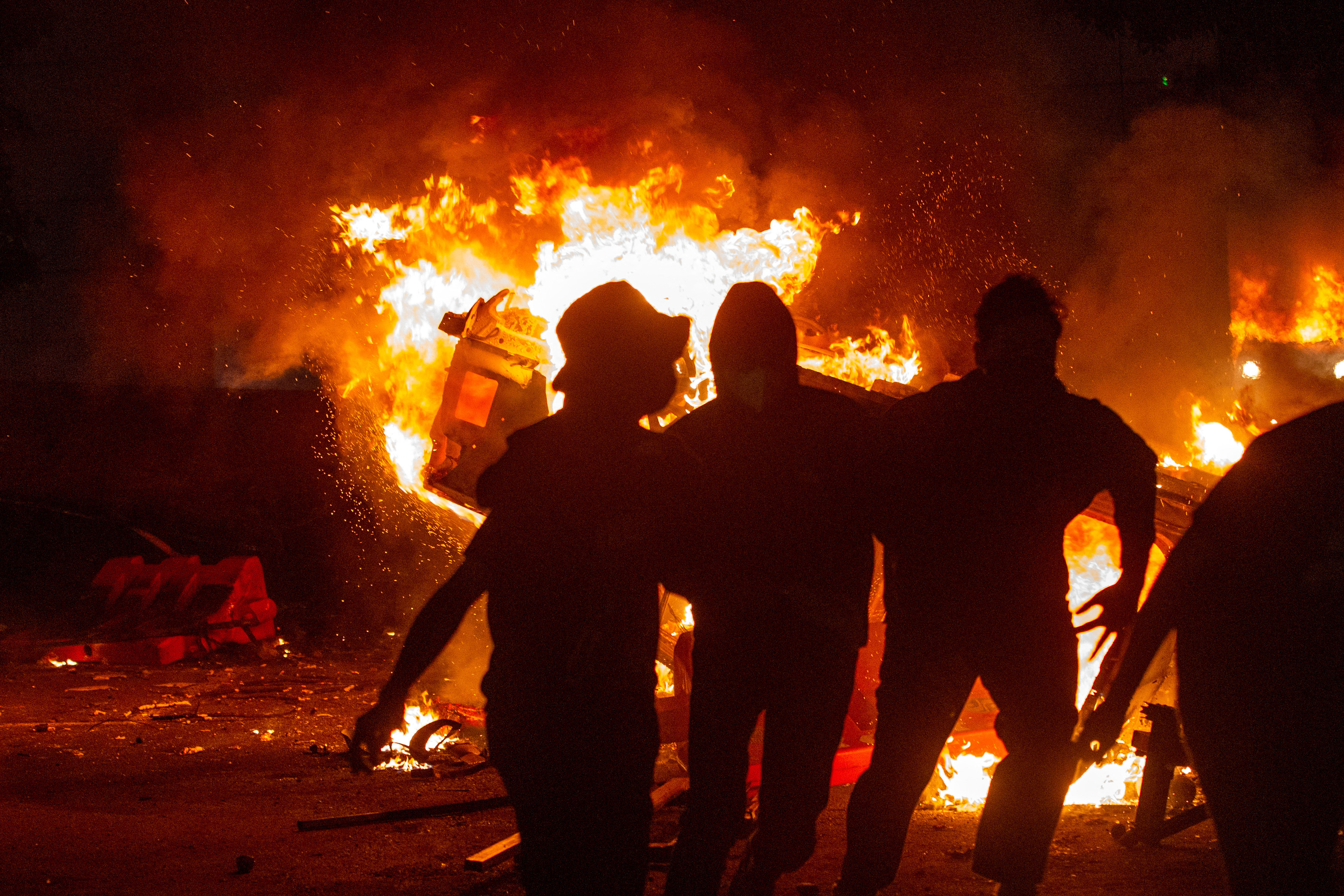 A car is set on fire during a protest in Yogyakarta on August 29, 2025, following the death of a motorcycle taxi driver who was run over by an armoured Brimob (Mobile Brigade Corps) vehicle the night before. Protests erupted across several Indonesian cities on August 29 in anger at the death of a motorcycle taxi driver hit by a police vehicle, as officers responded with tear gas and the president called for calm. [Devi Rahman/AFP] (AFP)