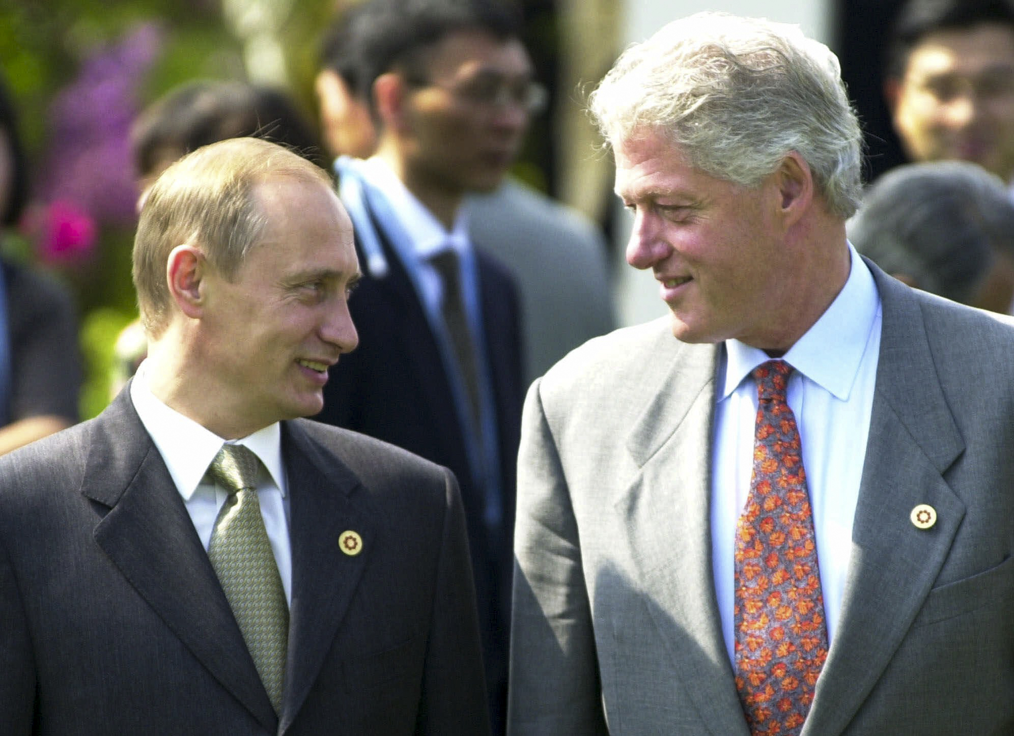 FILE In this Saturday, July 21, 2000 file photo President Bill Clinton shares a light moment with Russian President Vladimir Putin during a tree-planting ceremony at Bankokushinryokan or "bridge to the world," before the Group of Eight meeting in Nago, Okinawa, Japan. (AP Photo/Vincent Yu, File)