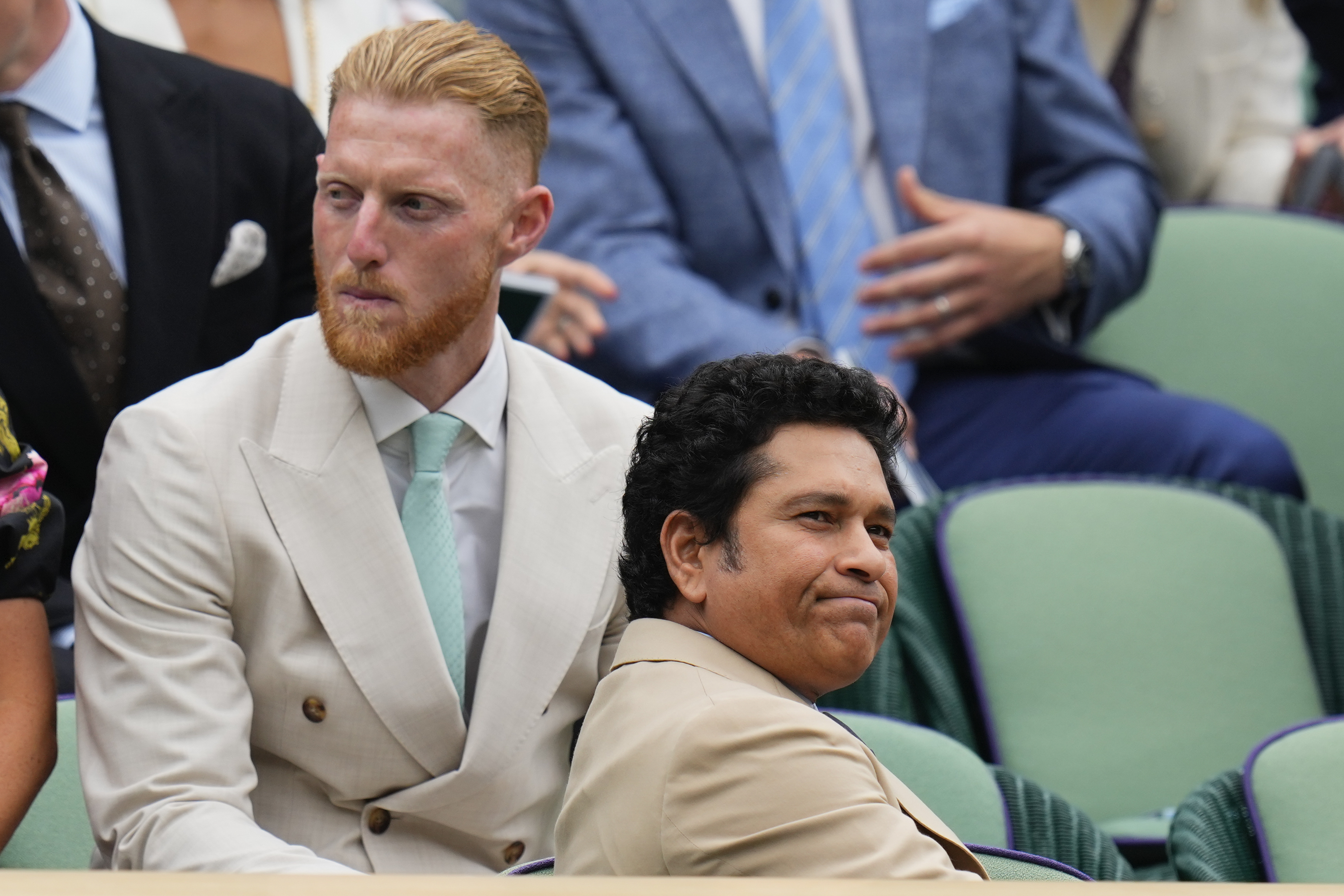 Sachin Tendulkar, right, and Ben Stokes watching tennis.