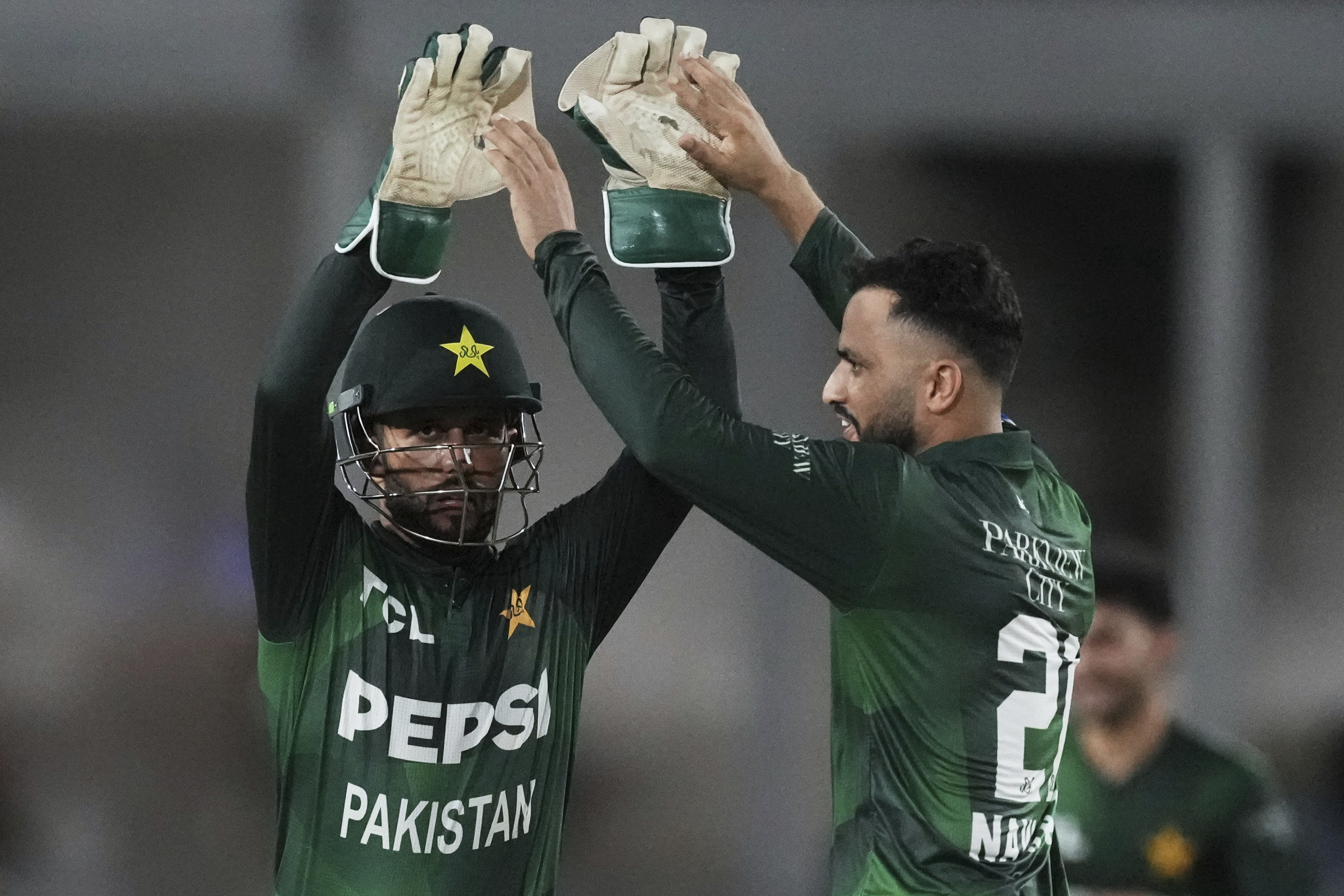 Pakistan's Mohammad Nawaz, right, celebrates with teammate after the dismissal of West Indies' Johnson Charles during the first Twenty20 cricket match between West Indies and Pakistan