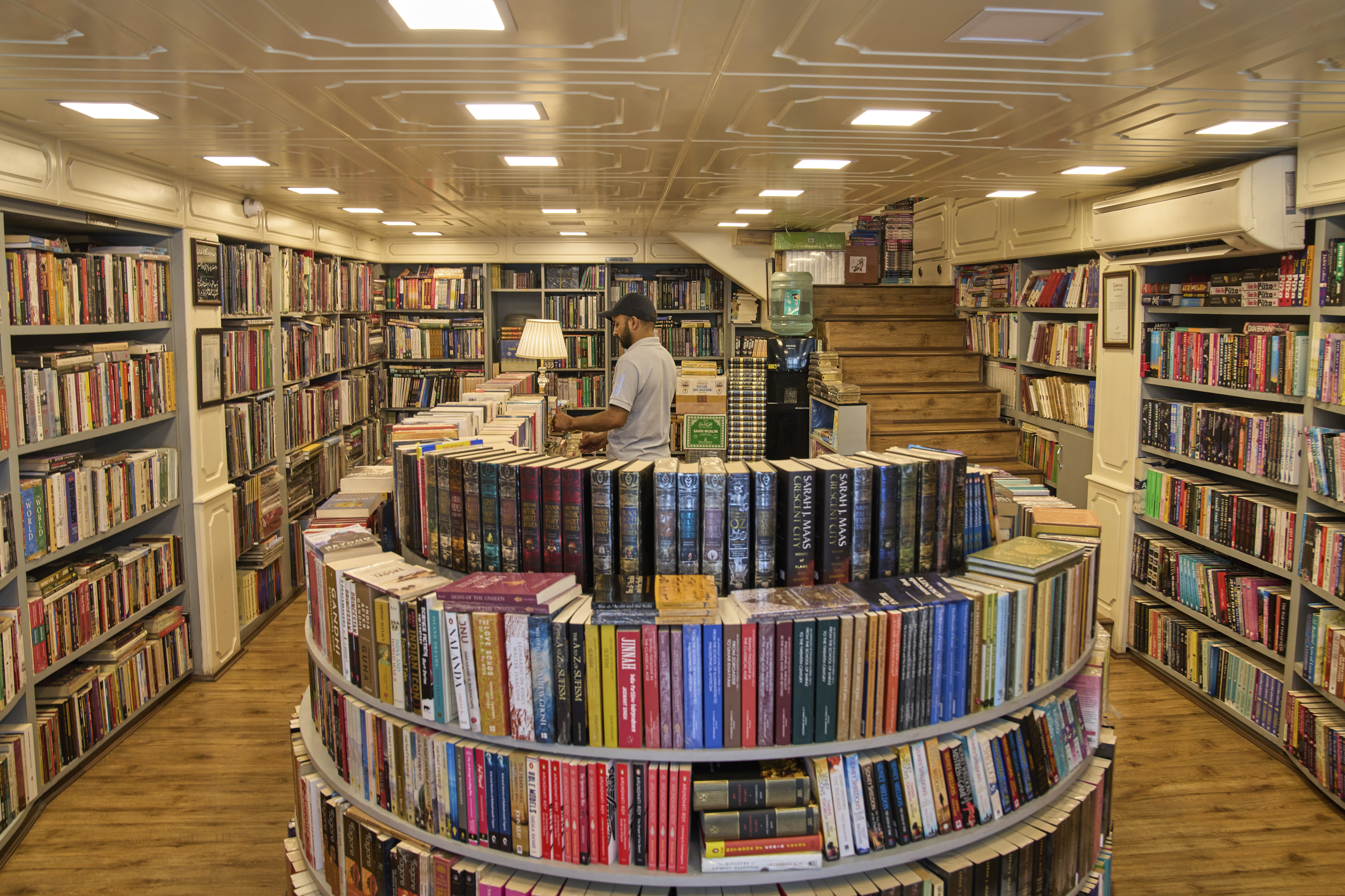A Kashmiri man arranges books in a bookstore in Srinagar, Indian-controlled Kashmir on August 7, 2025.