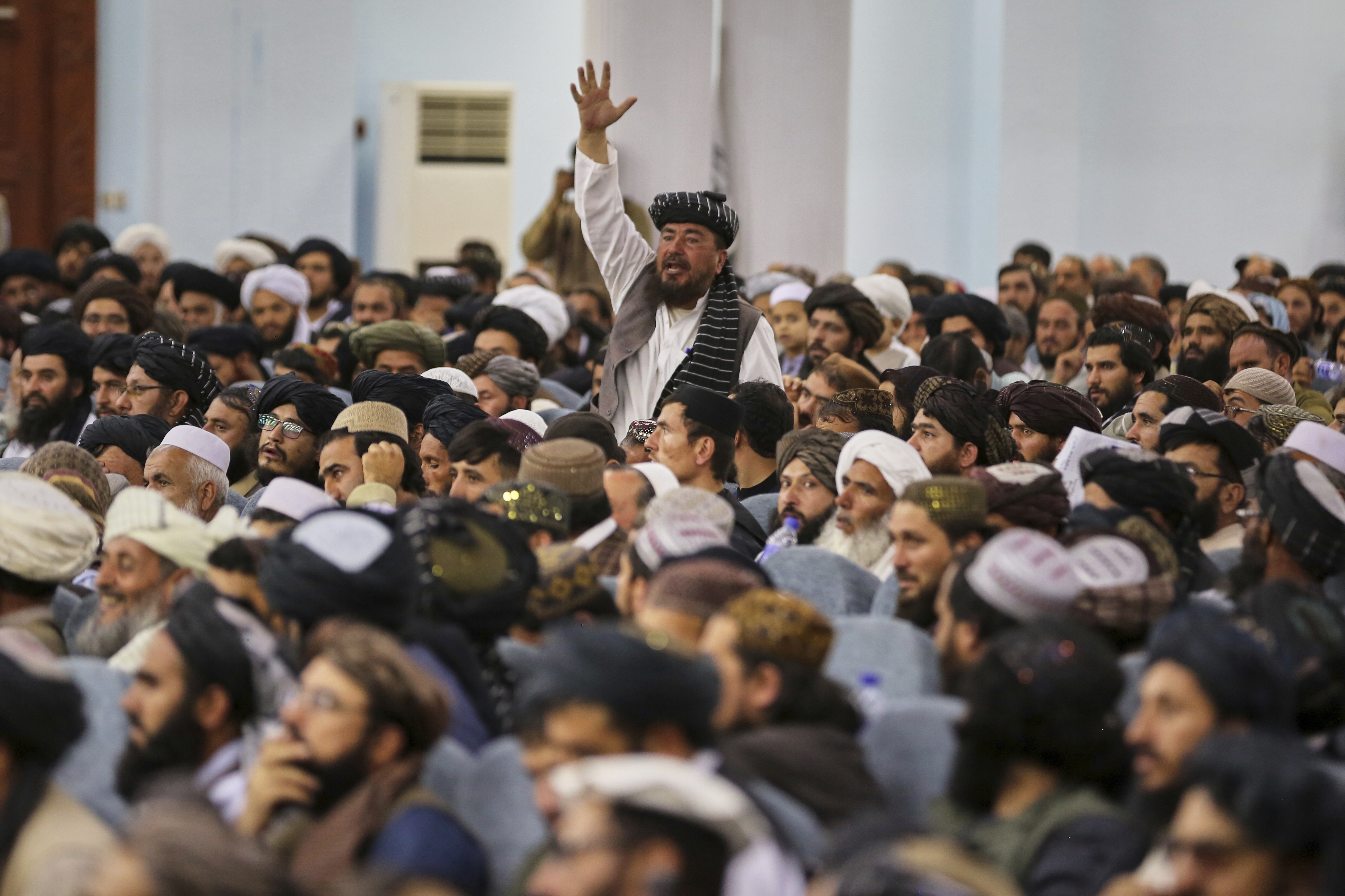 A man shouts during a meeting of delegates that opens Victory Day celebrations at Loya Jirga Hall in Kabul