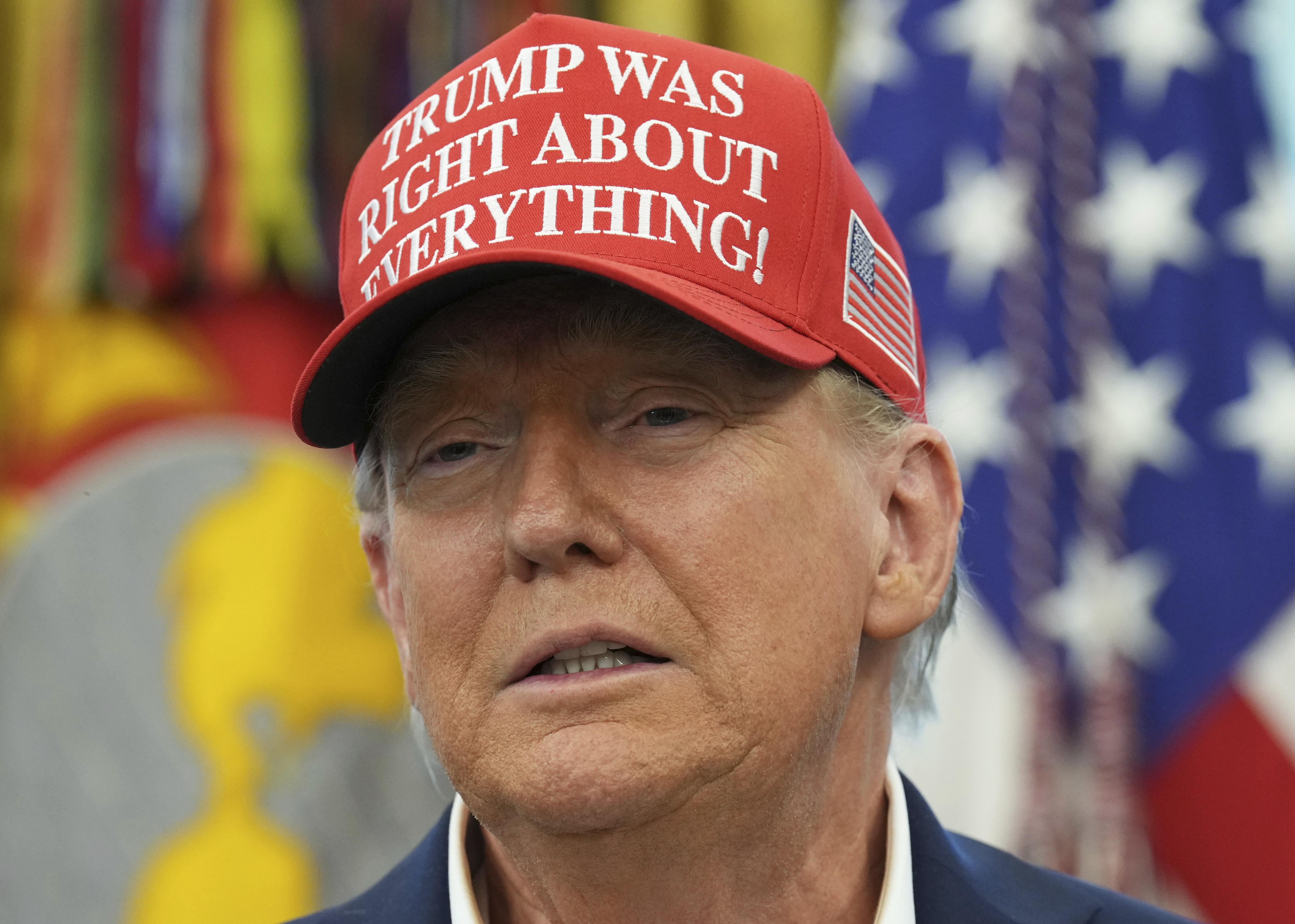 Donald Trump in a red cap that reads: "Trump was right about everything."