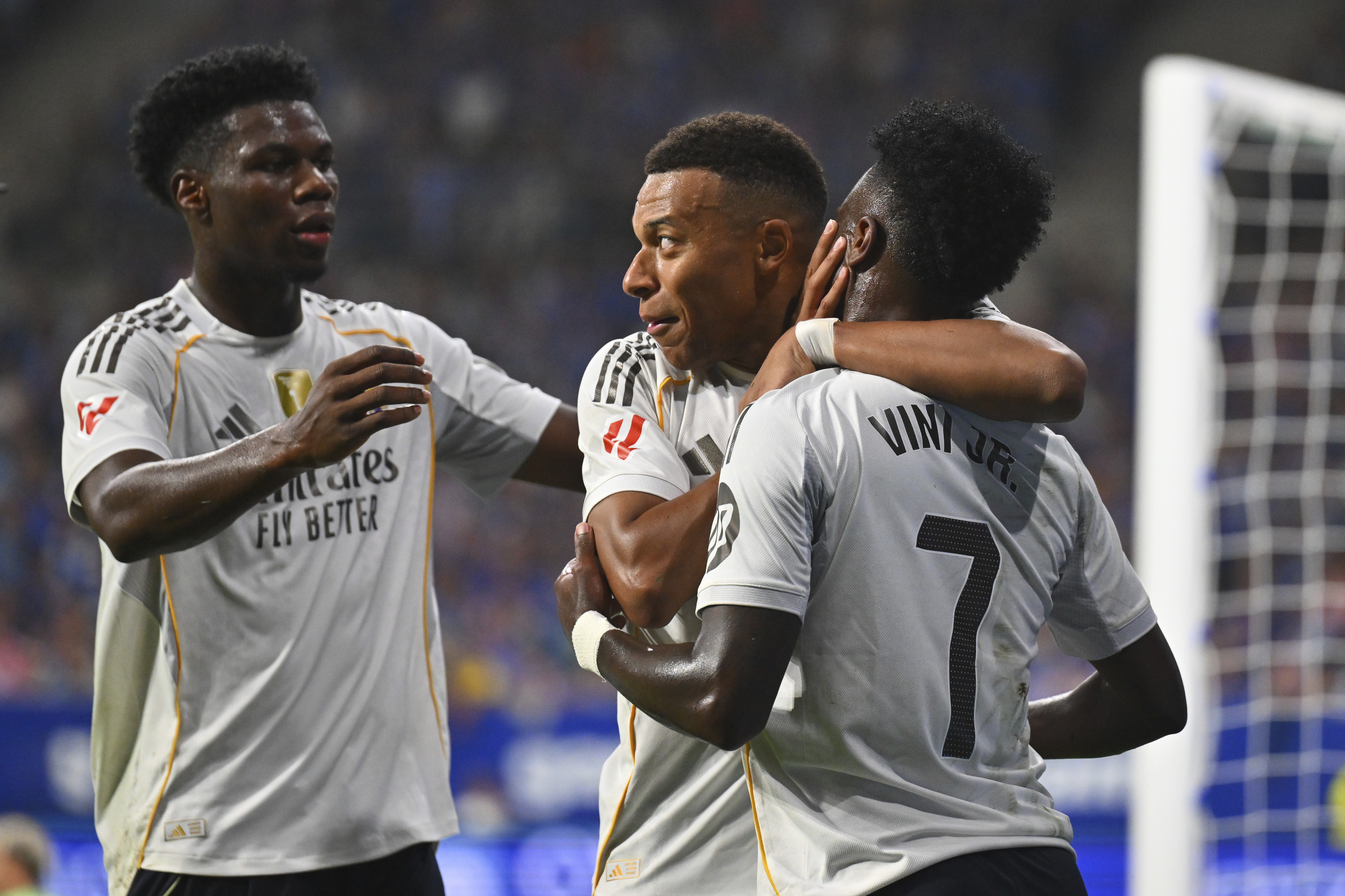 Real Madrid's Kylian Mbappe, center, is congratulated by teammates Vinicius Junior, right, and Aurelien Tchouameni after scoring