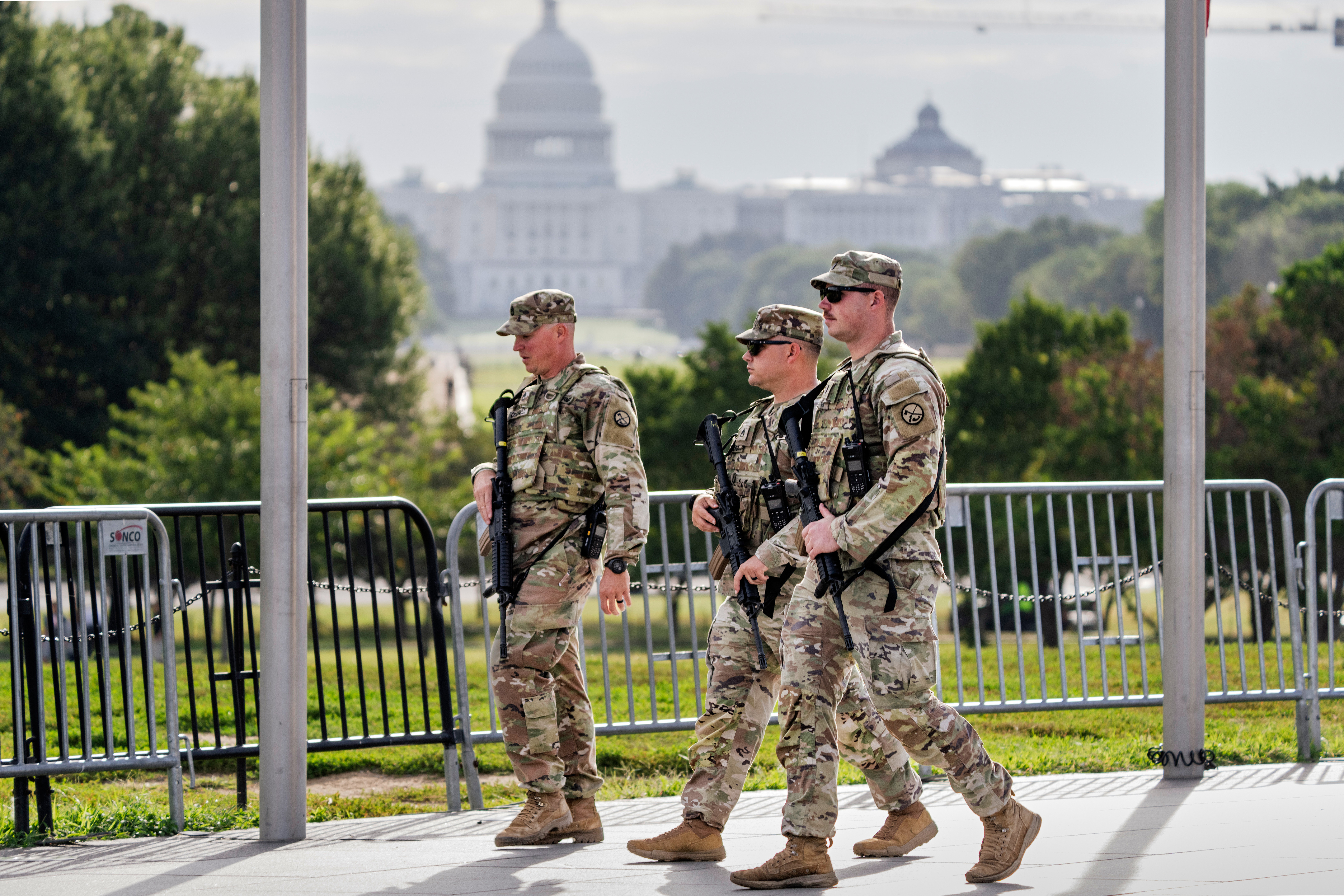 Troops patrol in front of the Capitol.