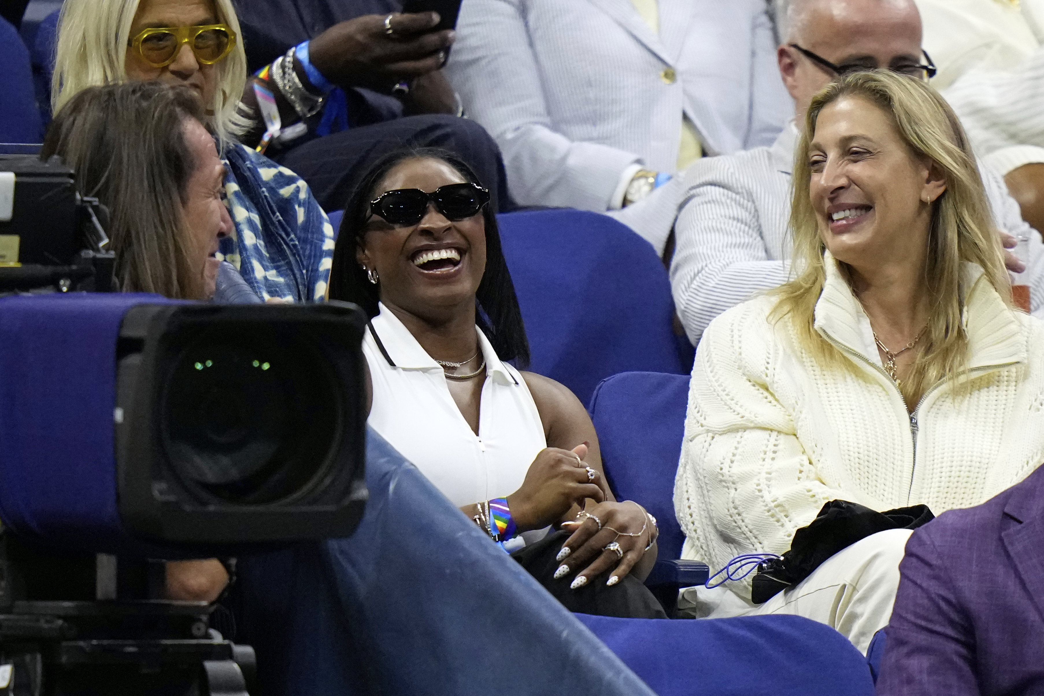 Gymnast Simone Biles, center, reacts after Coco Gauff, of the United States, mentioned her following Gauff's match against Donna Vekic, of Croatia, during the second round of the U.S. Open tennis championships