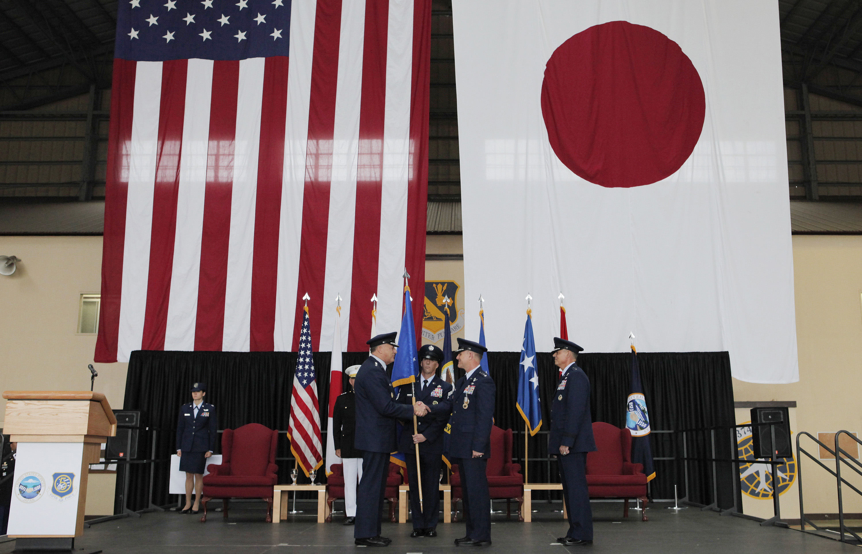 U.S. Pacific Air Forces Commander Gen. Gary L. North, fourth from right, shakes hands with outgoing U.S. Forces Japan Commander Lt. Burton M. Field, second from right, as incoming U.S. Forces Japan Commander Lt. Gen. Salvatore A. Angelella, right, stands behind Field during their change of command ceremony at Yokota Air Base, on the outskirts of Tokyo, Friday, July 20, 2012. (AP Photo/Itsuo Inouye)