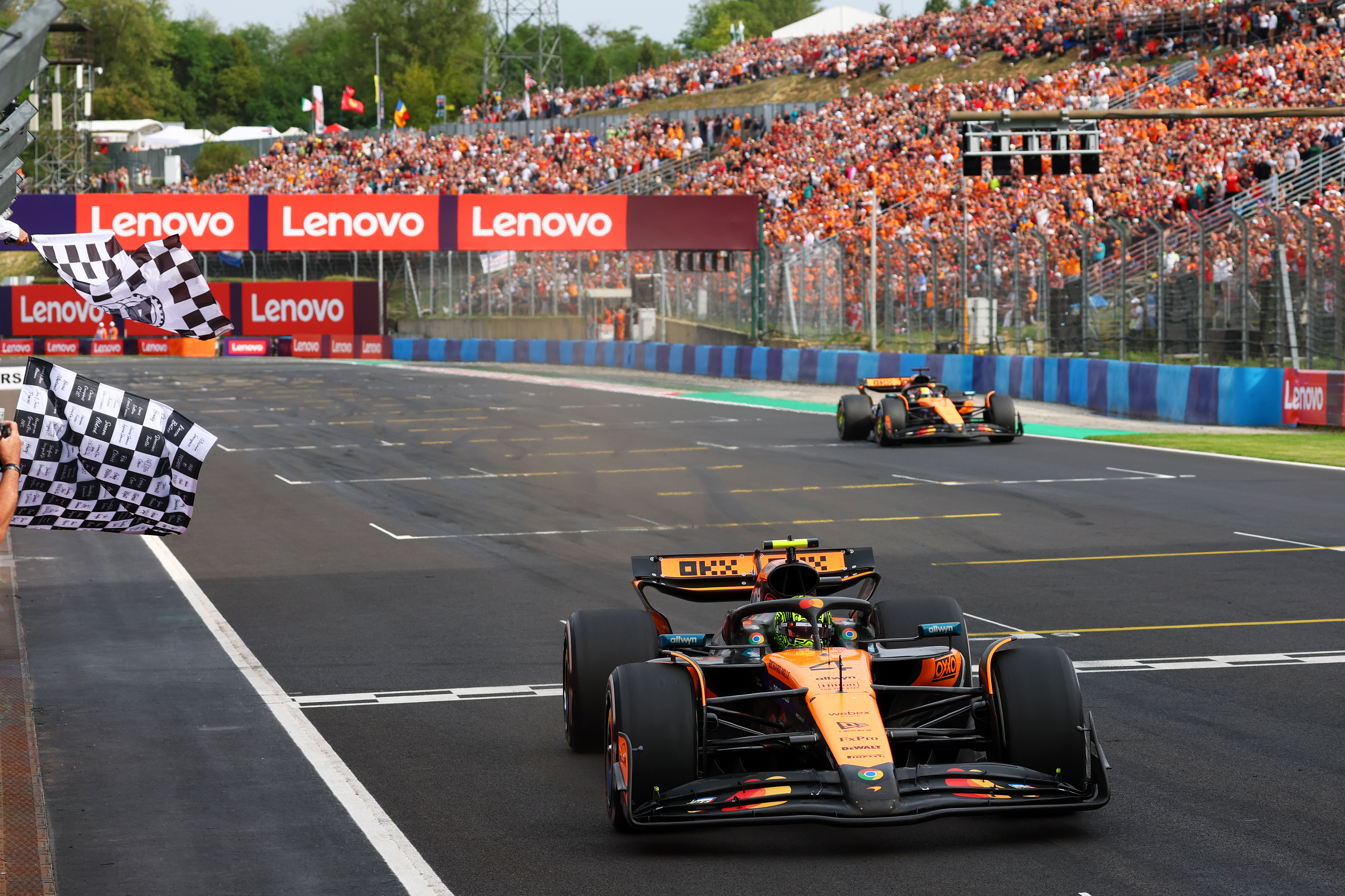 Race winner Lando Norris of Great Britain driving the (4) McLaren MCL39 Mercedes takes the chequered flag during the F1 Grand Prix of Hungary