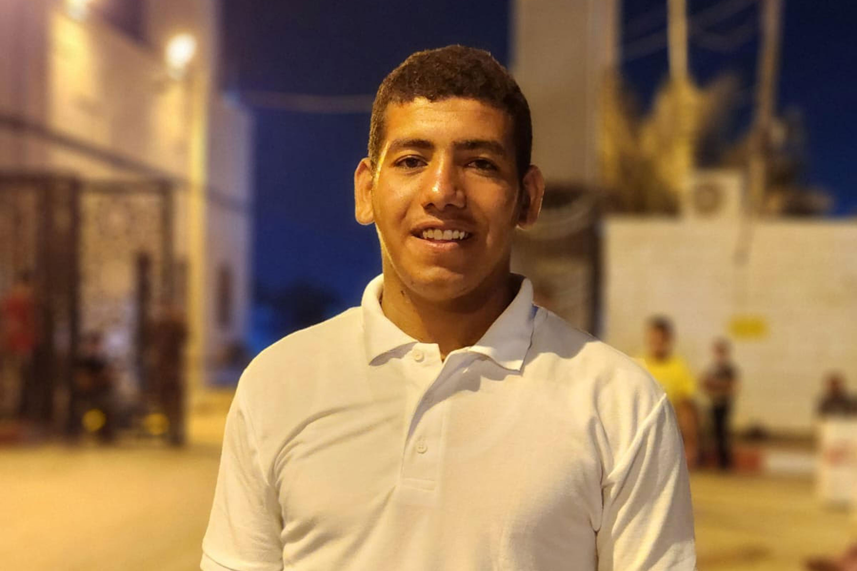 A photo of a young man taken at night