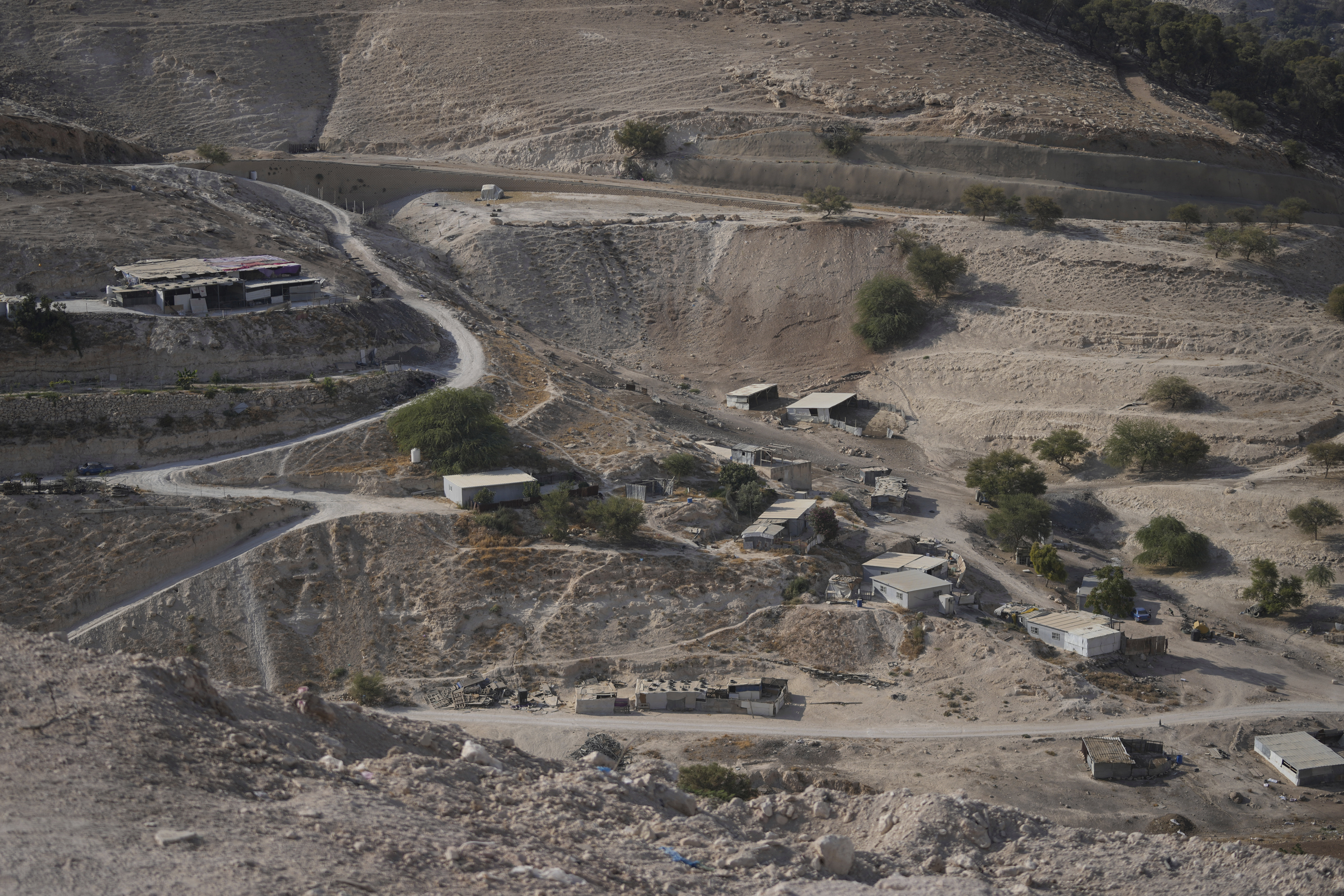 Palestinian hamlets are seen at the E1 area, an open tract of land east of Jerusalem, between the Israeli settlement of Maale Adumim and the occupied West Bank town of Eizariya Thursday, Aug. 14, 2025. (AP Photo/Nasser Nasser)