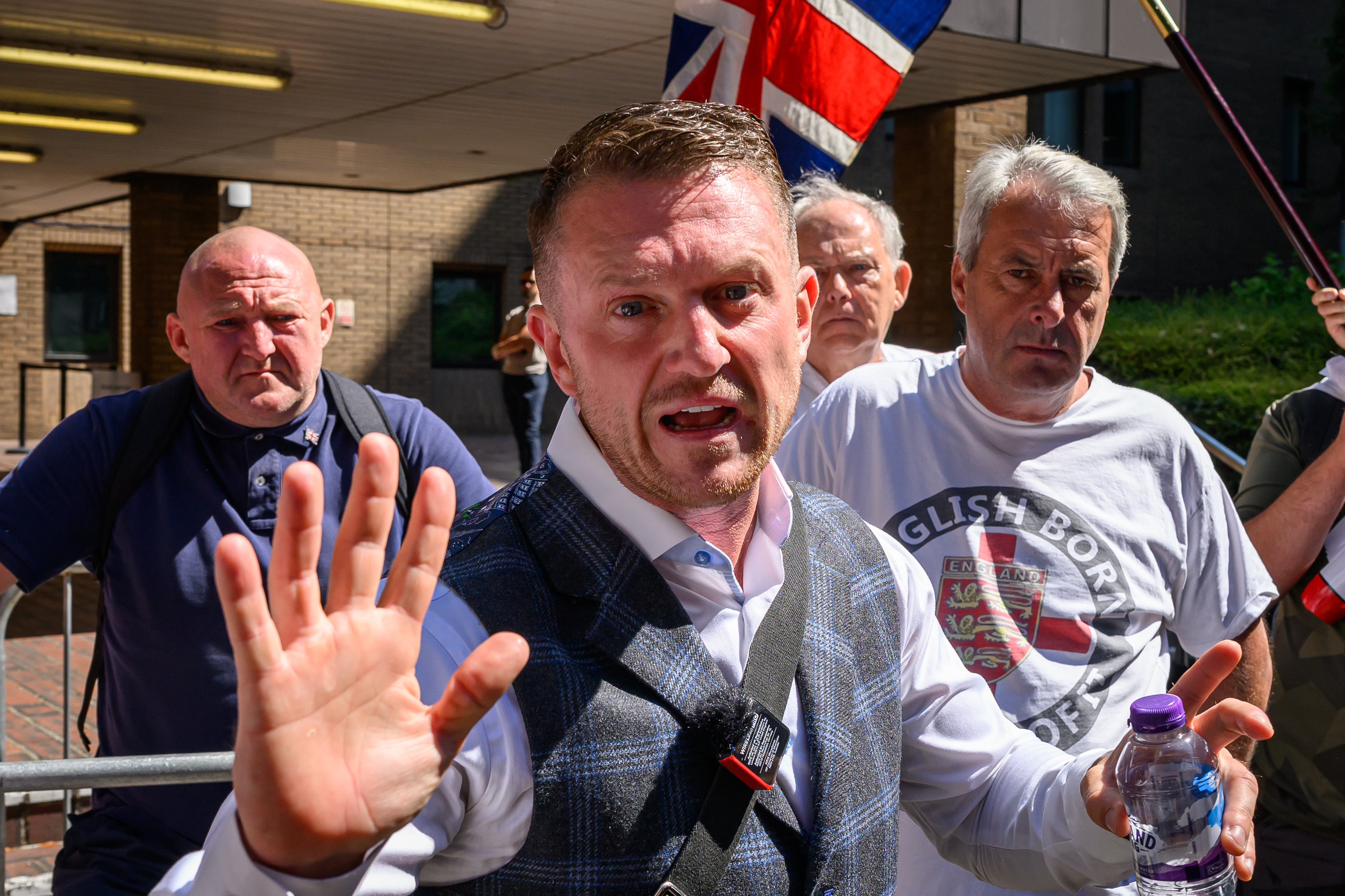 Stephen Yaxley-Lennon, also known as Tommy Robinson, speaks to supporters and members of the media as he leaves Southwark Crown Court in London on July 3, 2025 [Leon Neal/Getty Images]