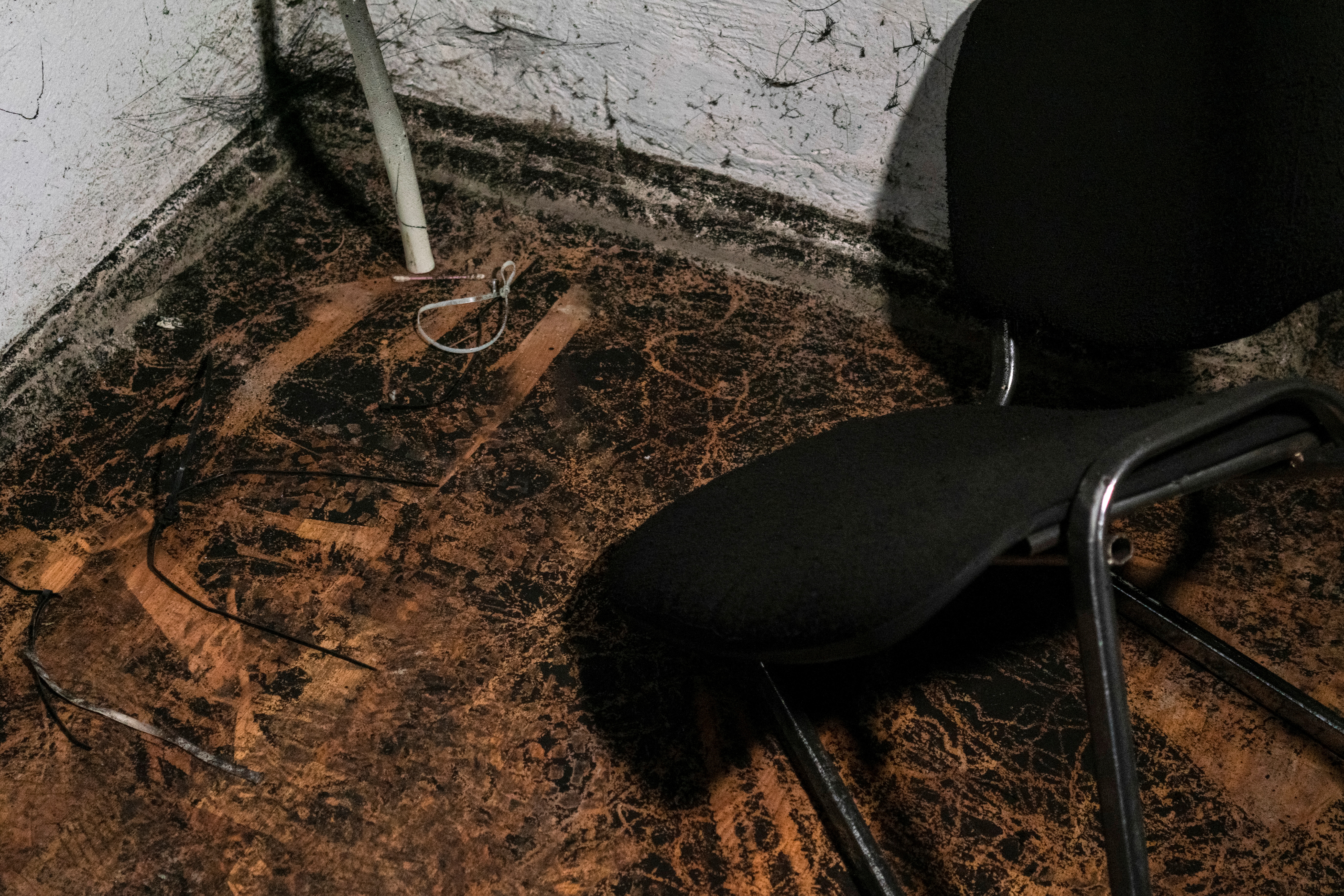 Plastic ties for tortures and a broken chair are seen inside a basement of an office building, where prosecutors say 30 people were held two months during a Russian occupation, amid Russia's attack on Ukraine, in Kherson, Ukraine, December 10, 2022. REUTERS/Anna Voitenko