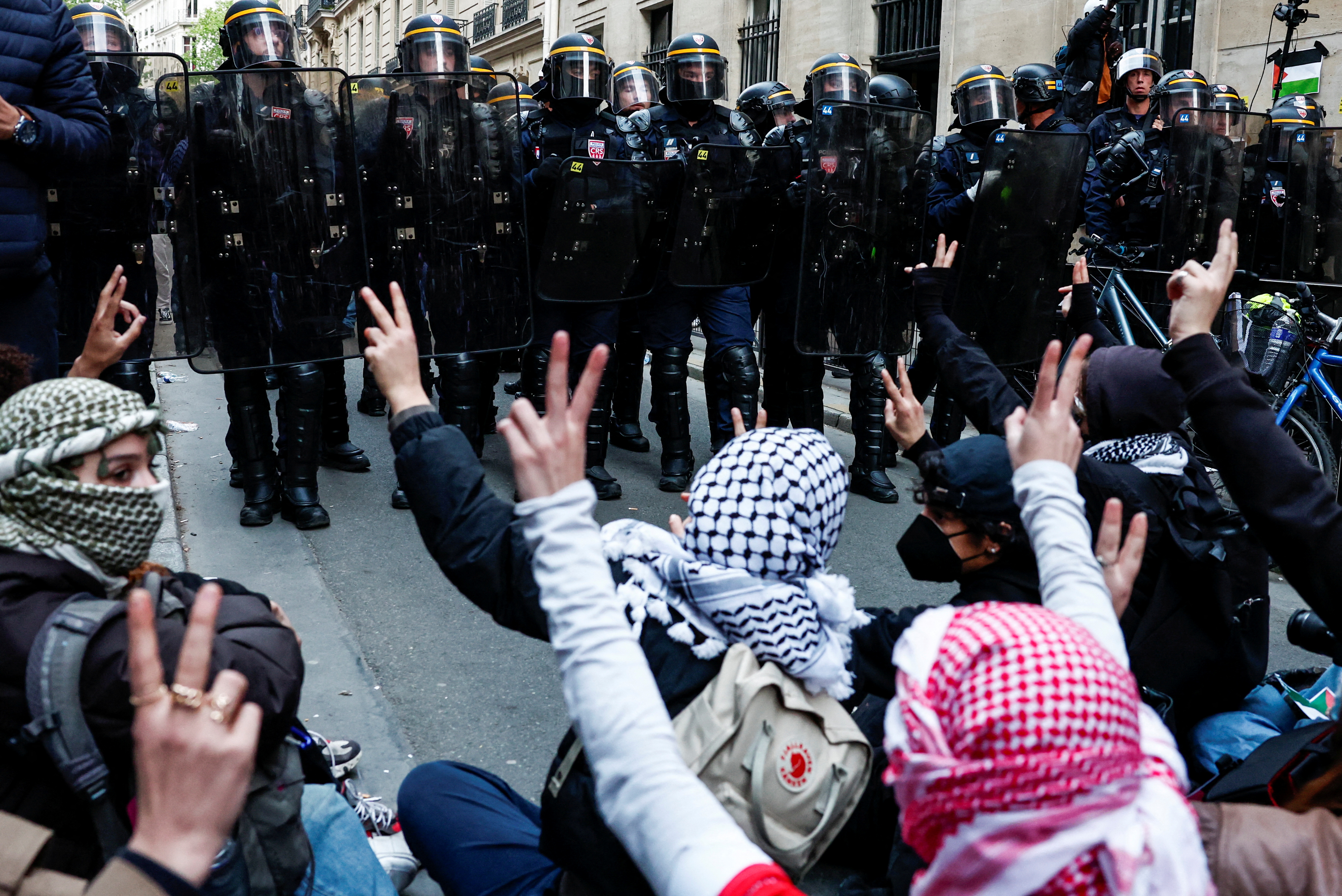 Police officers stand guard as youths take part in the occupation of a street in front of the building of the Sciences Po University in support of Palestinians in Gaza, during the ongoing conflict between Israel and the Palestinian Islamist group Hamas, in Paris, France, April 26, 2024. REUTERS/Gonzalo Fuentes