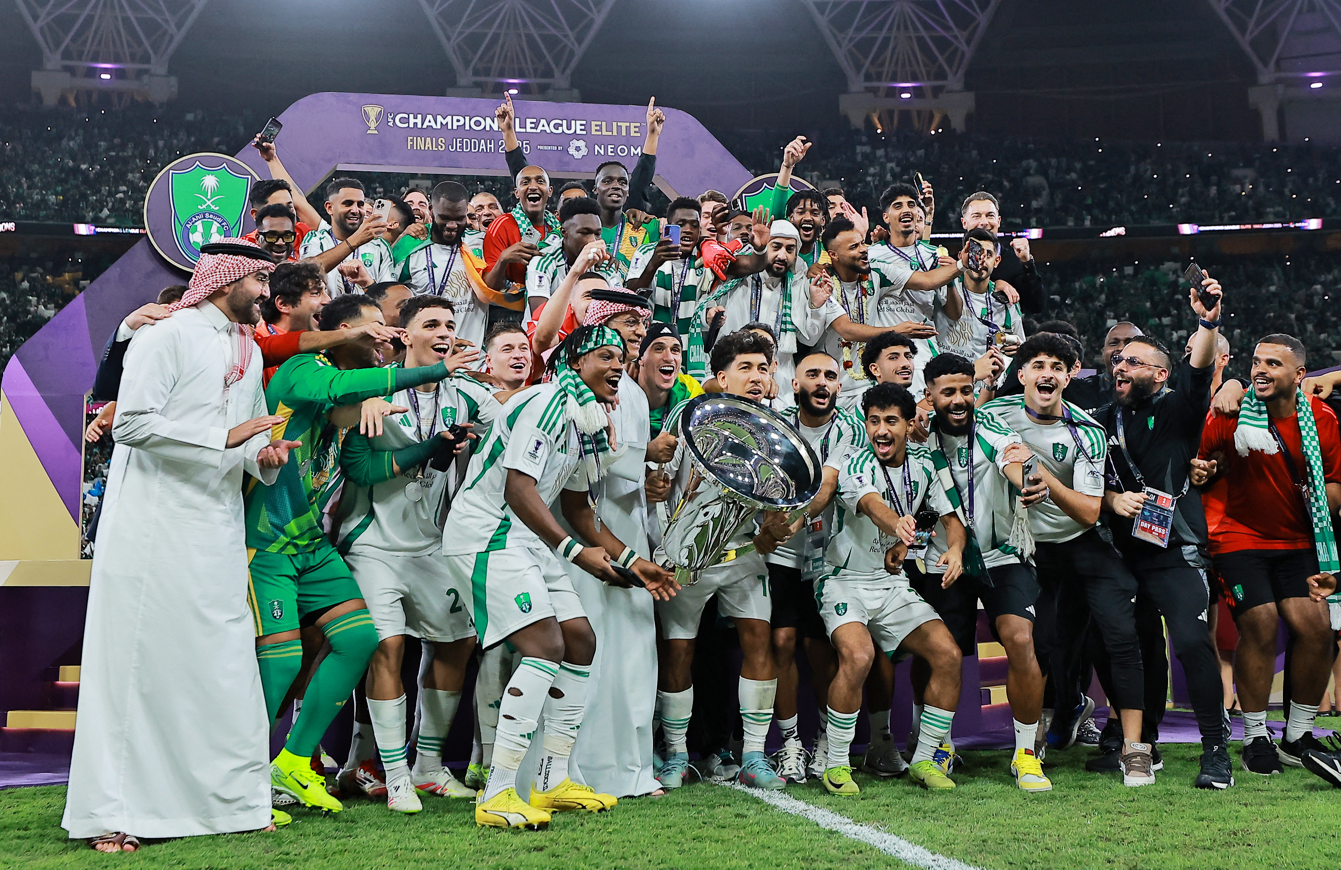 Al Ahli's Roberto Firmino lifts the trophy as he celebrates with teammates after winning the Asian Champions League 