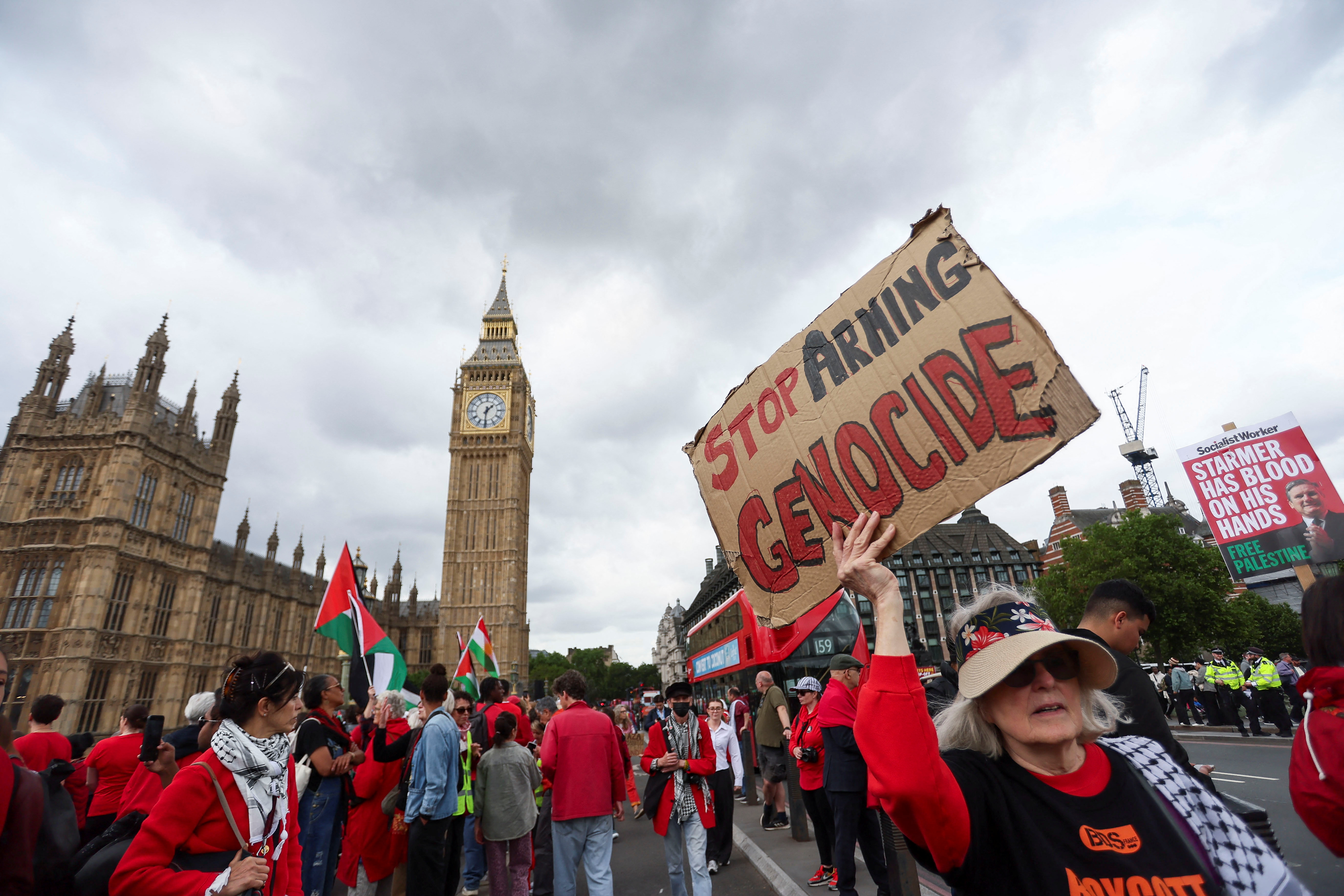 Pro-Palestinian protesters attend a demonstration outside the UK Parliament.