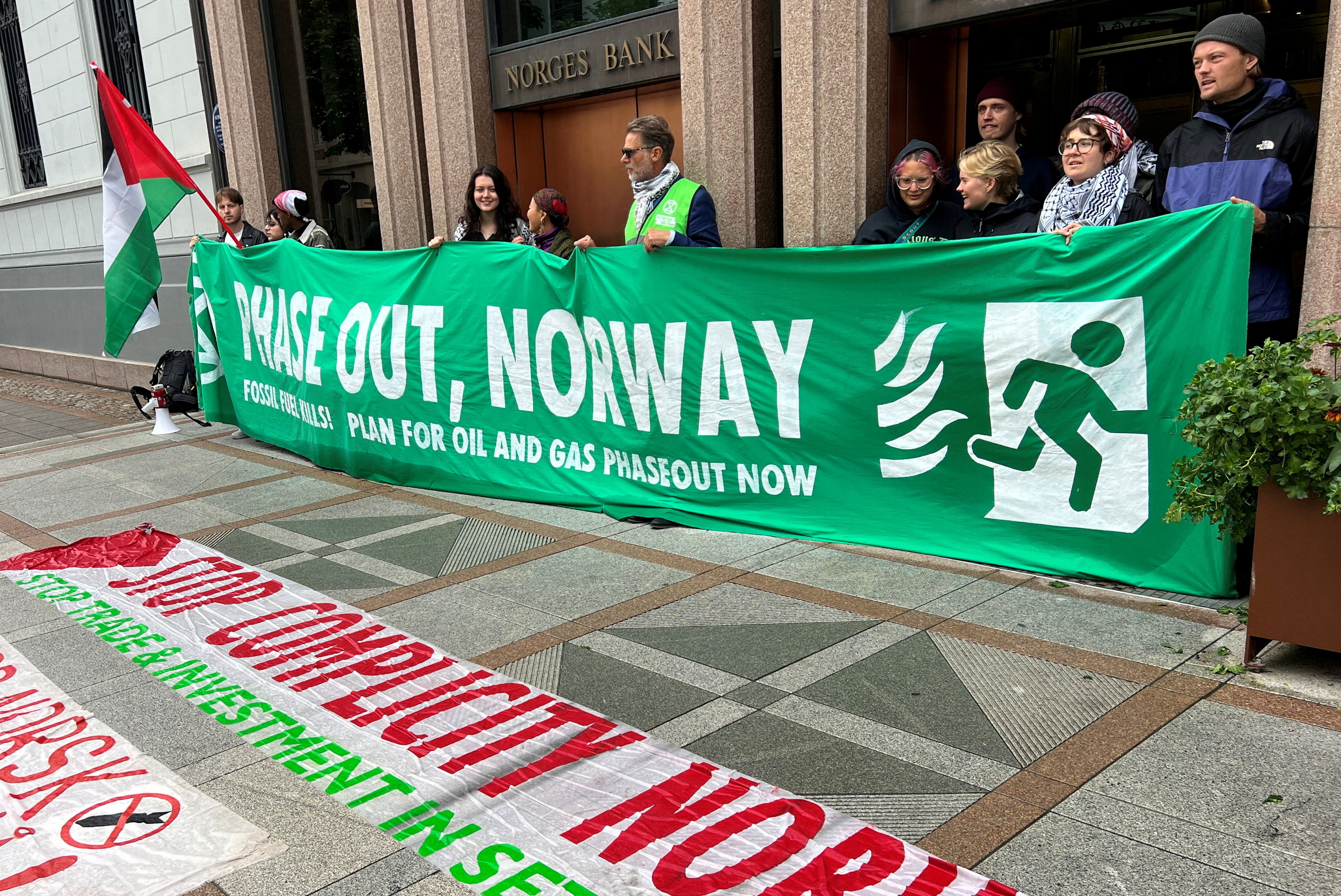 Pro-Palestinian and climate change activists block the entrances of the Norwegian central bank, which houses the offices of the sovereign wealth fund, in Oslo, Norway [File: Gwladys Fouche/Reuters]