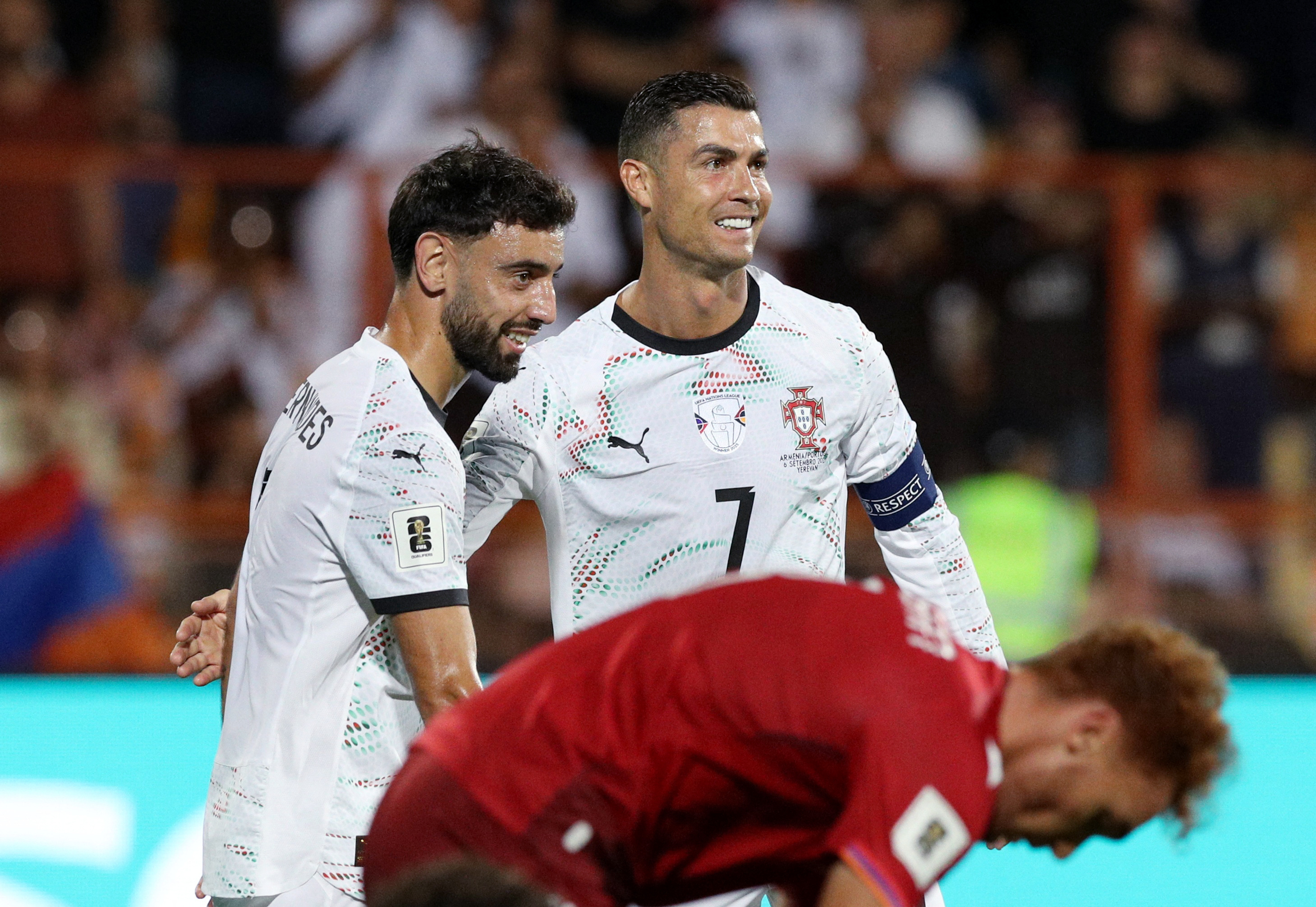 Portugal's Cristiano Ronaldo and Bruno Fernandes celebrate their third goal scored by Joao Cancelo