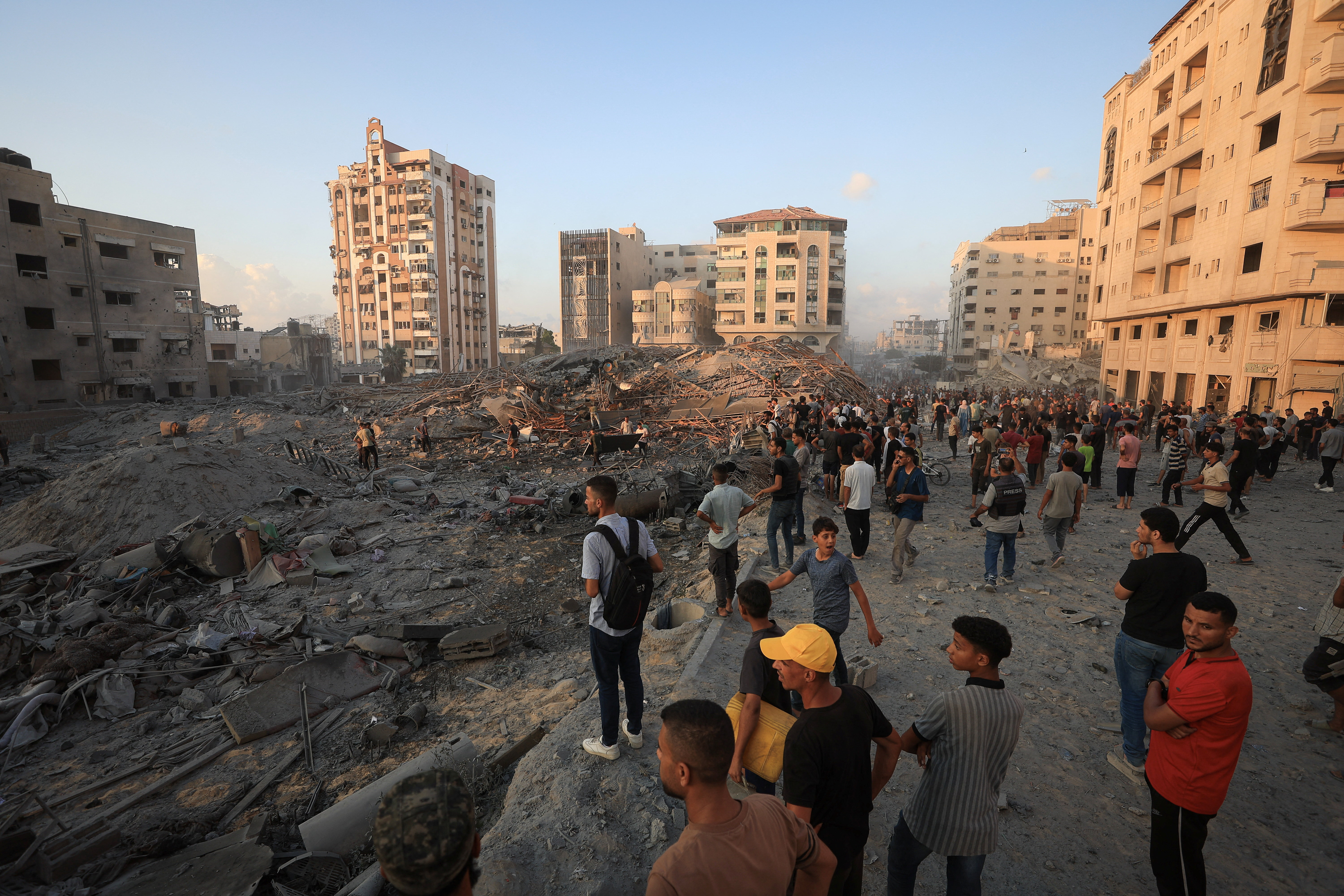 Palestinians inspect the site of a collapsed residential building, shortly after it was hit in an Israeli air strike, in Gaza City, September 7, 2025. REUTERS/Dawoud Abu Alkas