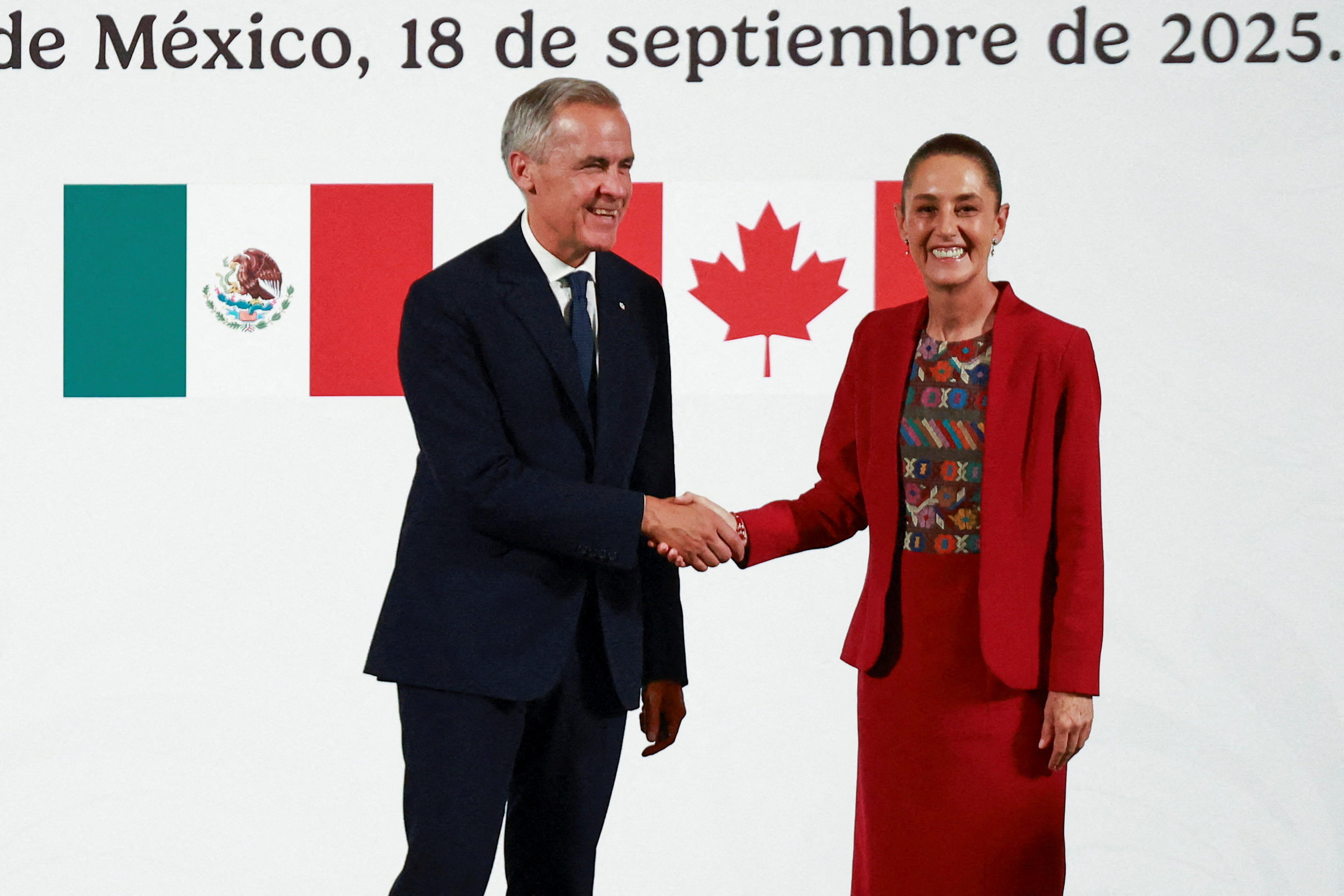 Mexican President Claudia Sheinbaum and Canadian Prime Minister Mark Carney shake hands as they hold a press conference at the National Palace, in Mexico City, Mexico September 18, 2025. (Raquel Cunha/Reuters)