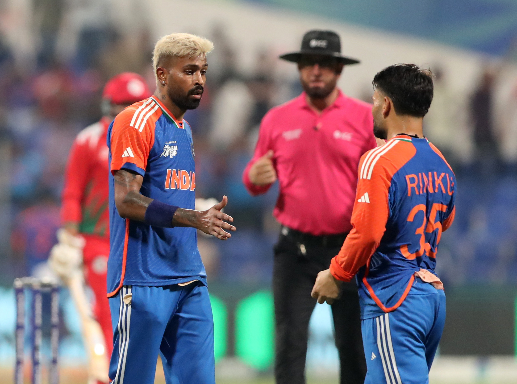 India's Rinku Singh celebrates with Hardik Pandya after taking the catch to dismiss Oman's Hammad Mirza off the bowling of Hardik Pandya