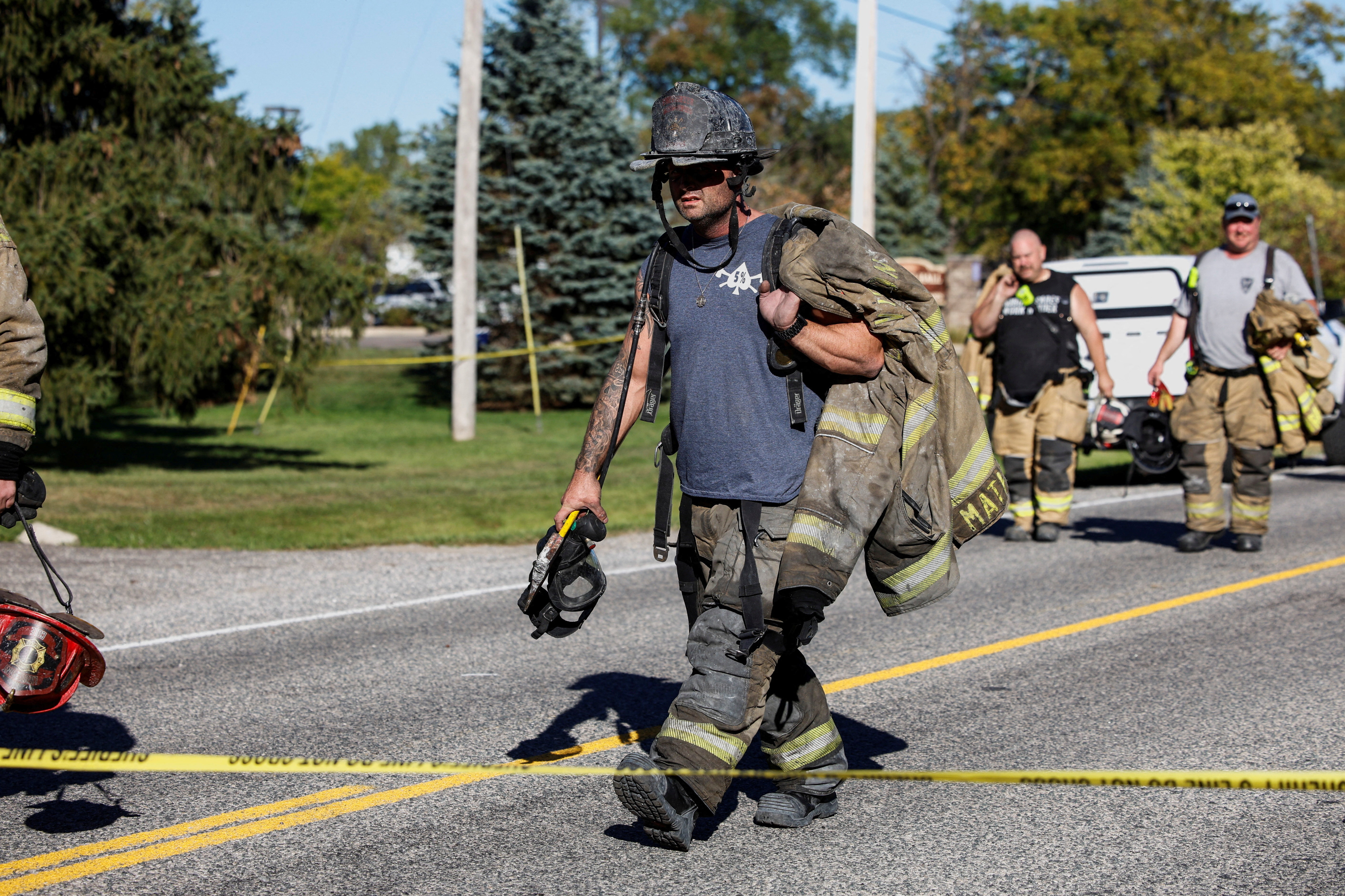 Firefighters walk away from the scene of a shooting at the Church of Jesus Christ of Latter-day Saints, in Grand Blanc, Michigan, US, September 28, 2025. [Rebecca Cook/Reuters]