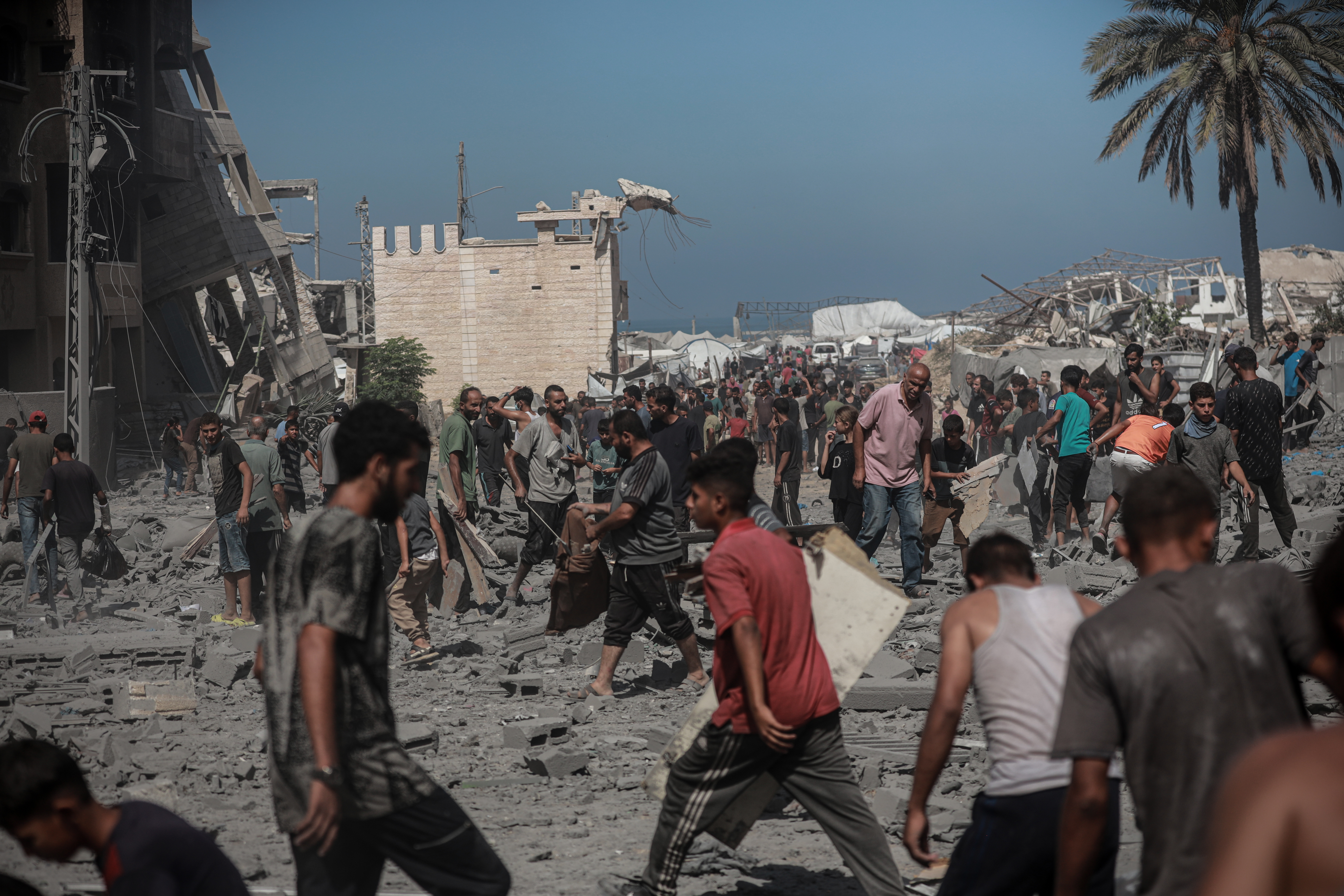 GAZA CITY, GAZA - SEPTEMBER 14: Residents of the area search for usable items among the rubble following the Israeli army targeted the Kevser Apartment Building in Gaza City, Gaza, on September 14, 2025. As a result of Israeli air strikes, numerous buildings and high-rise towers in the city of Gaza were hit and destroyed. ( Abdalhkem Abu Riash - Anadolu Agency )
