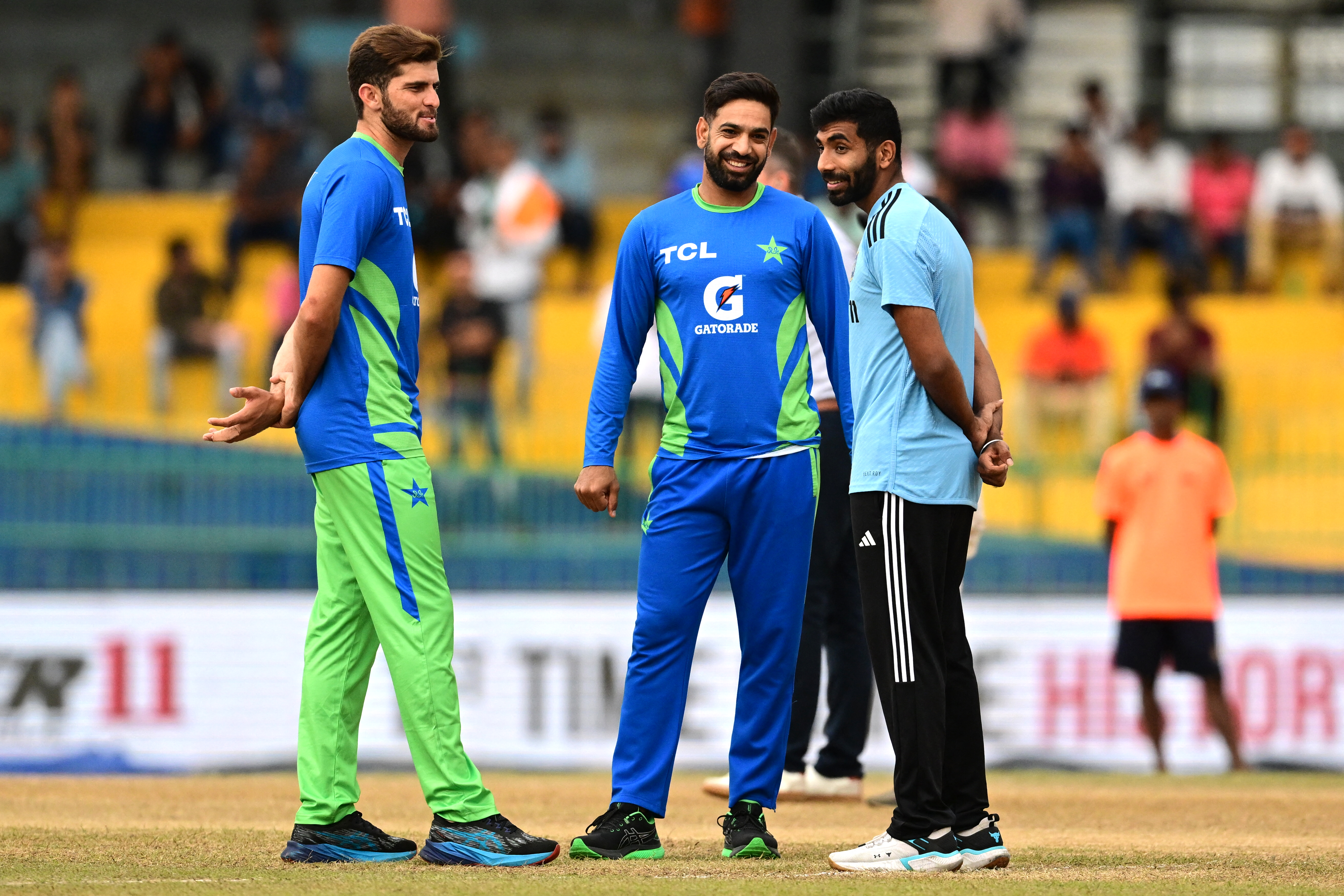India's Jasprit Bumrah (R) talks with Pakistan's Haris Rauf (C) and Shaheen Shah Afridi before the start of the Asia Cup 2023 super four one-day international (ODI) cricket match between India and Pakistan at the R. Premadasa Stadium in Colombo on September 11, 2023. (Photo by Ishara S. KODIKARA / AFP)