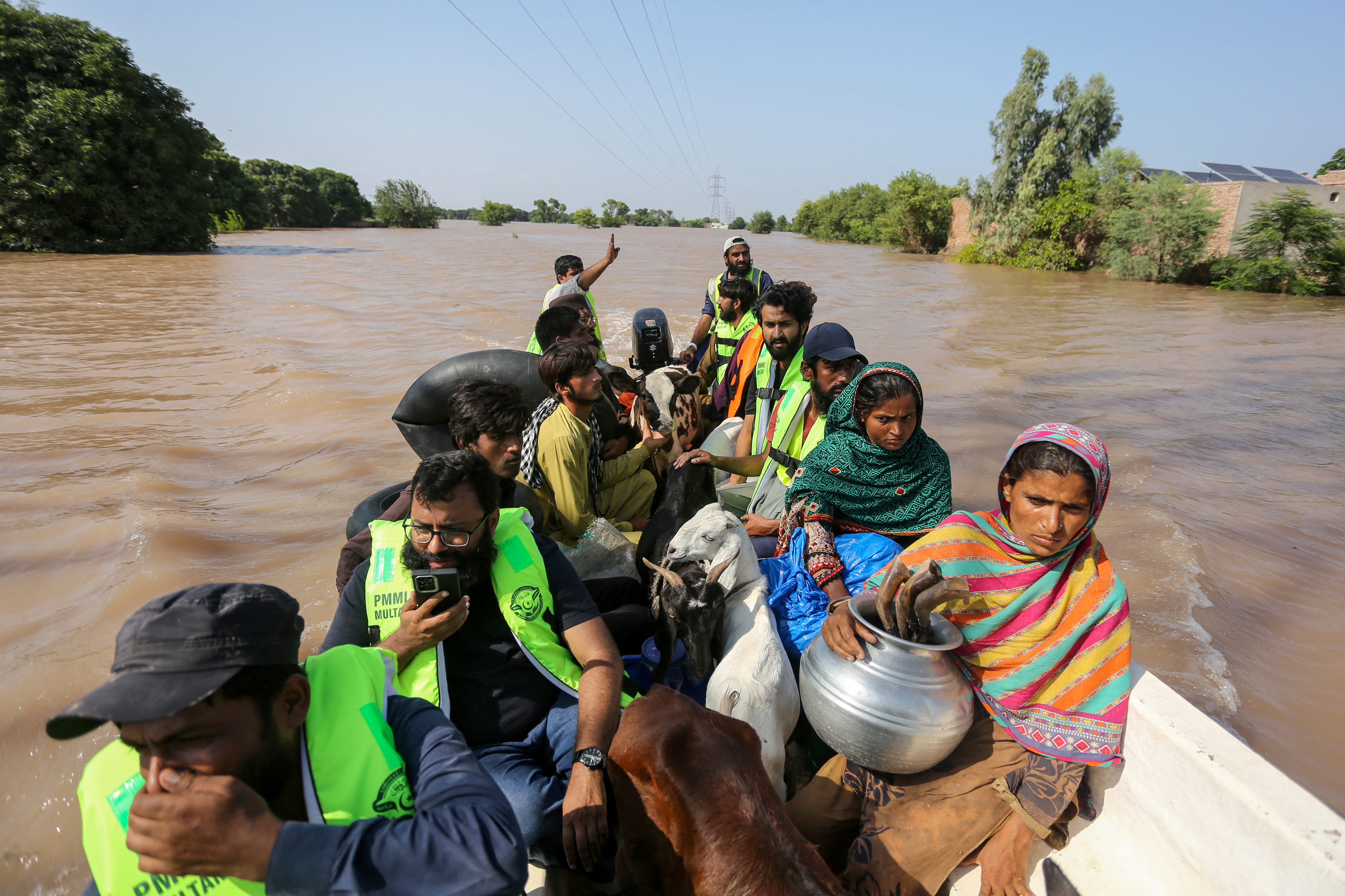 Volunteers rescue flood-affected victims along with their livestock using a boat following heavy rains and overflowing of the Sutlej river, on the outskirts of Multan in Punjab province, Pakistan on September 4, 2025.