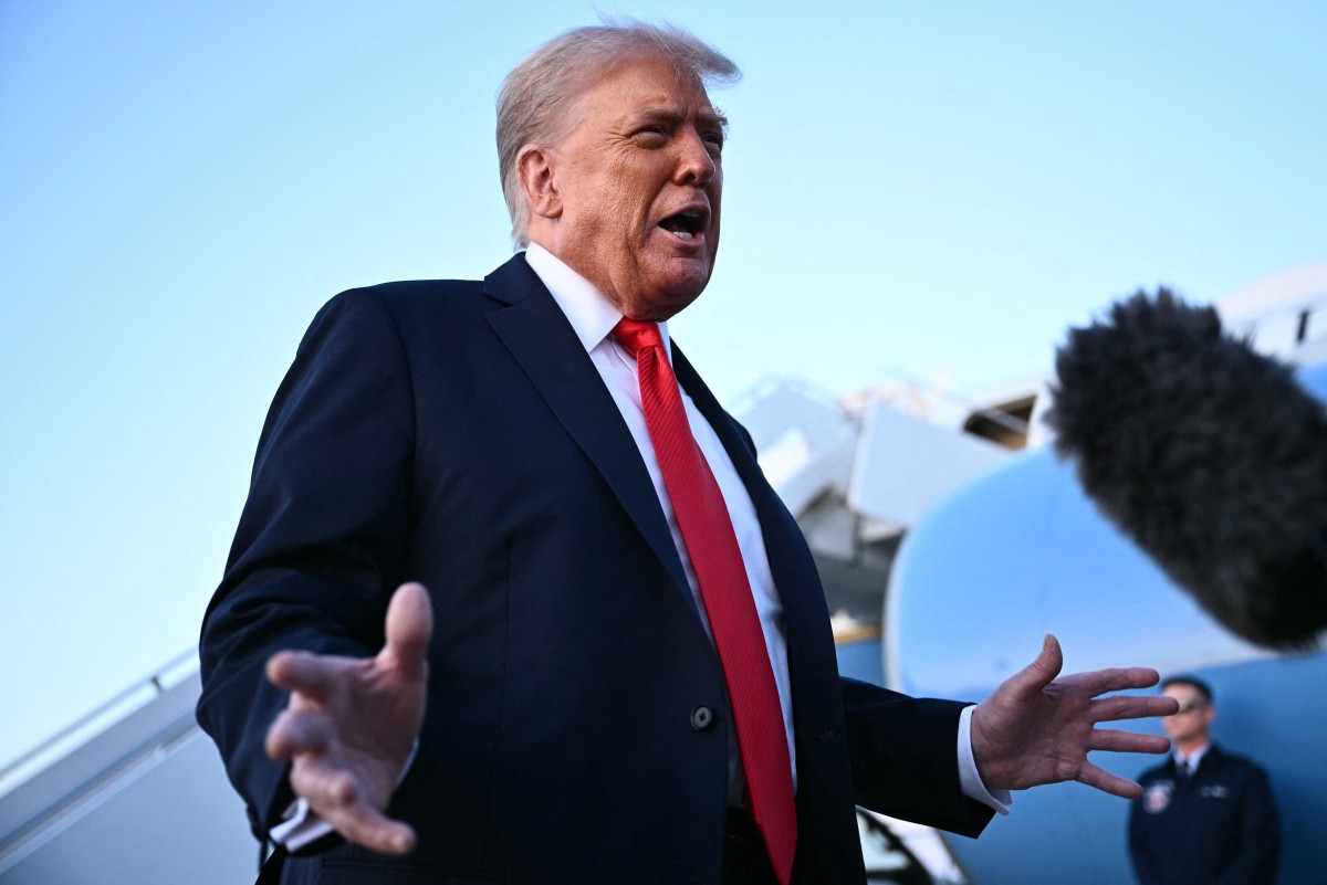 US President Donald Trump speaks to reporters after stepping off Air Force One upon returning to Joint Base Andrews in Maryland [File: Mandel Ngan/AFP]