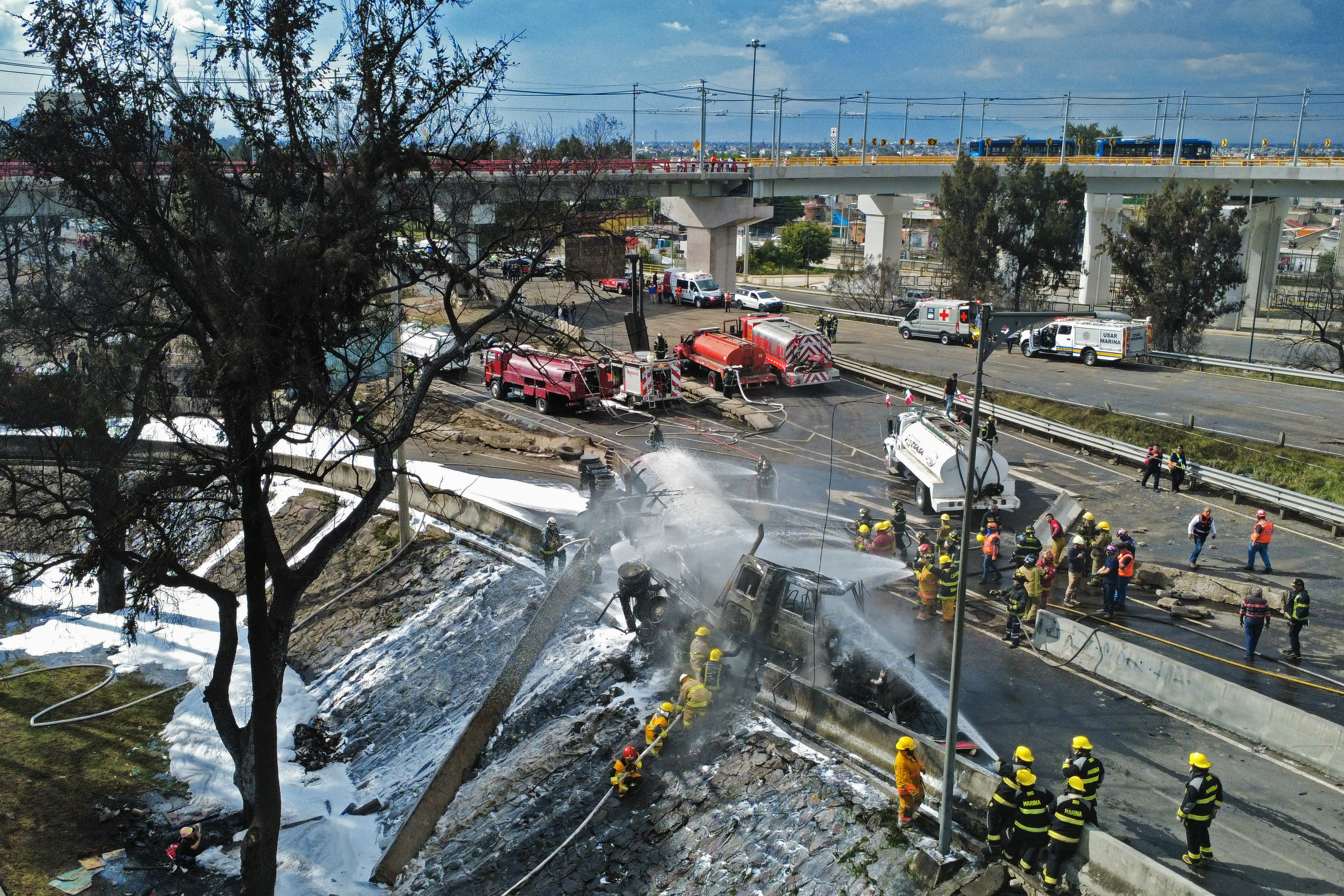 Firefighters extinguish the flames of a gas truck in Mexico City